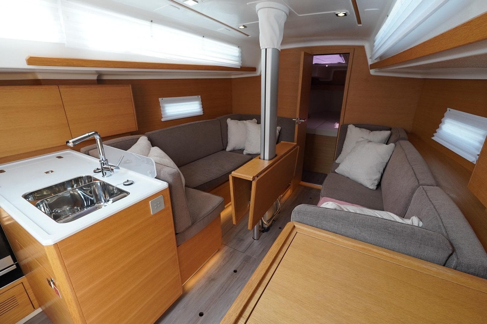 2022 Elan E4 yacht interior with modern kitchen and cozy seating area.