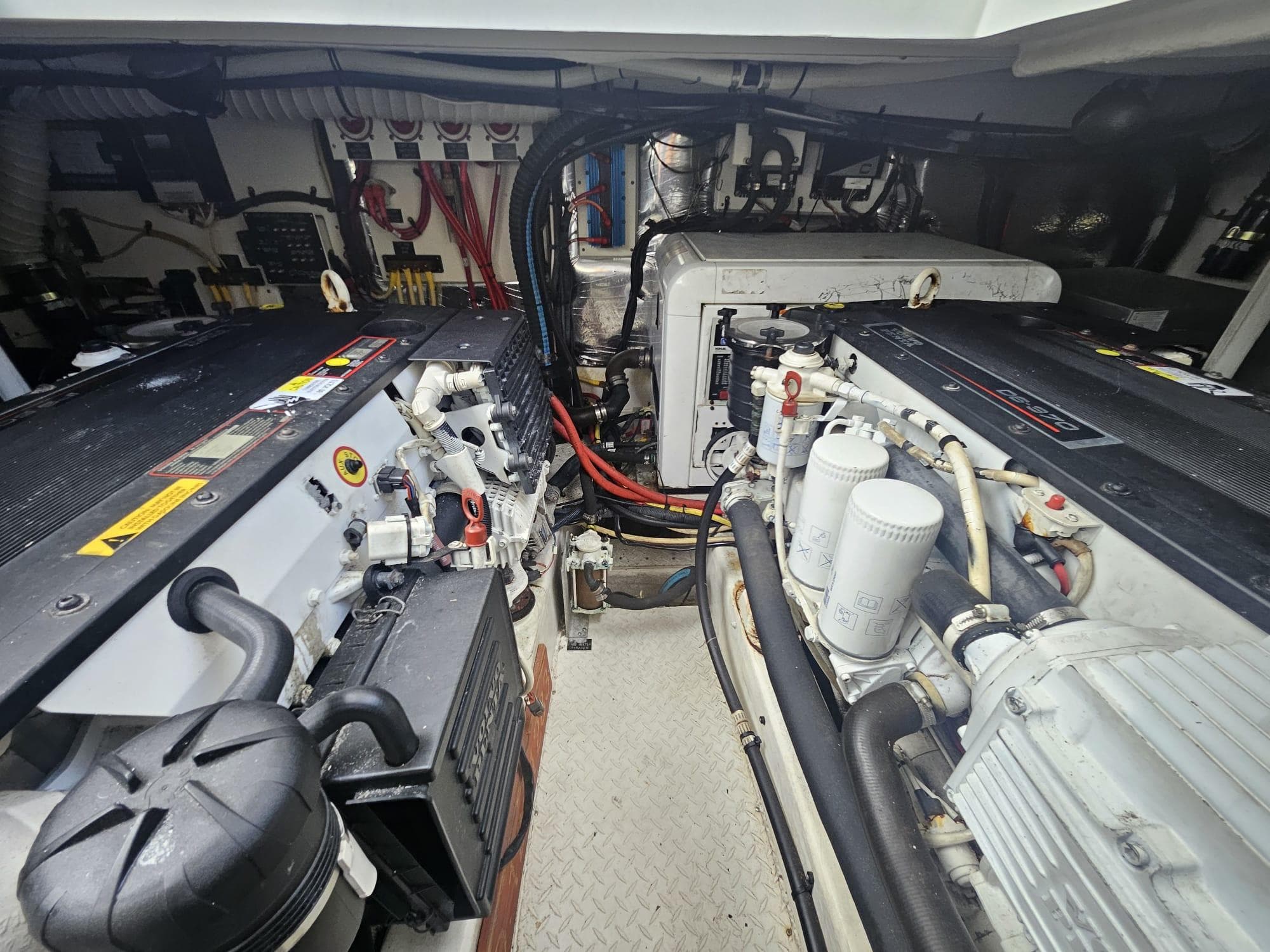 Engine room of 2008 Cruisers Yachts 390 Sports Coupe, showcasing dual engines and mechanical components.
