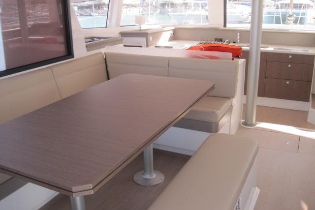 Modern interior of 2020 Bali 4.3 catamaran with dining area and kitchenette.