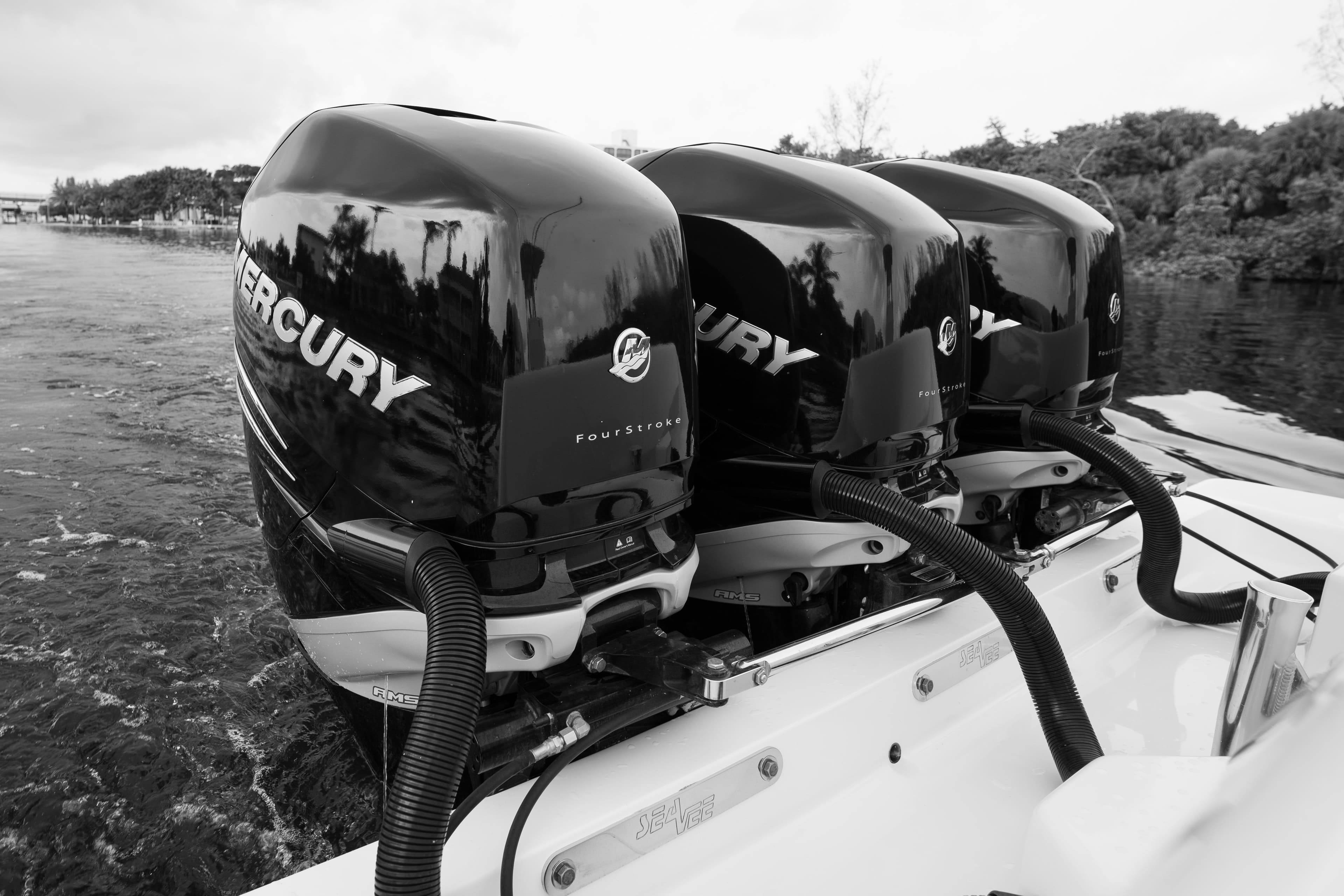 Triple Mercury outboard engines on a 2015 SeaVee 390Z boat, cruising on water.