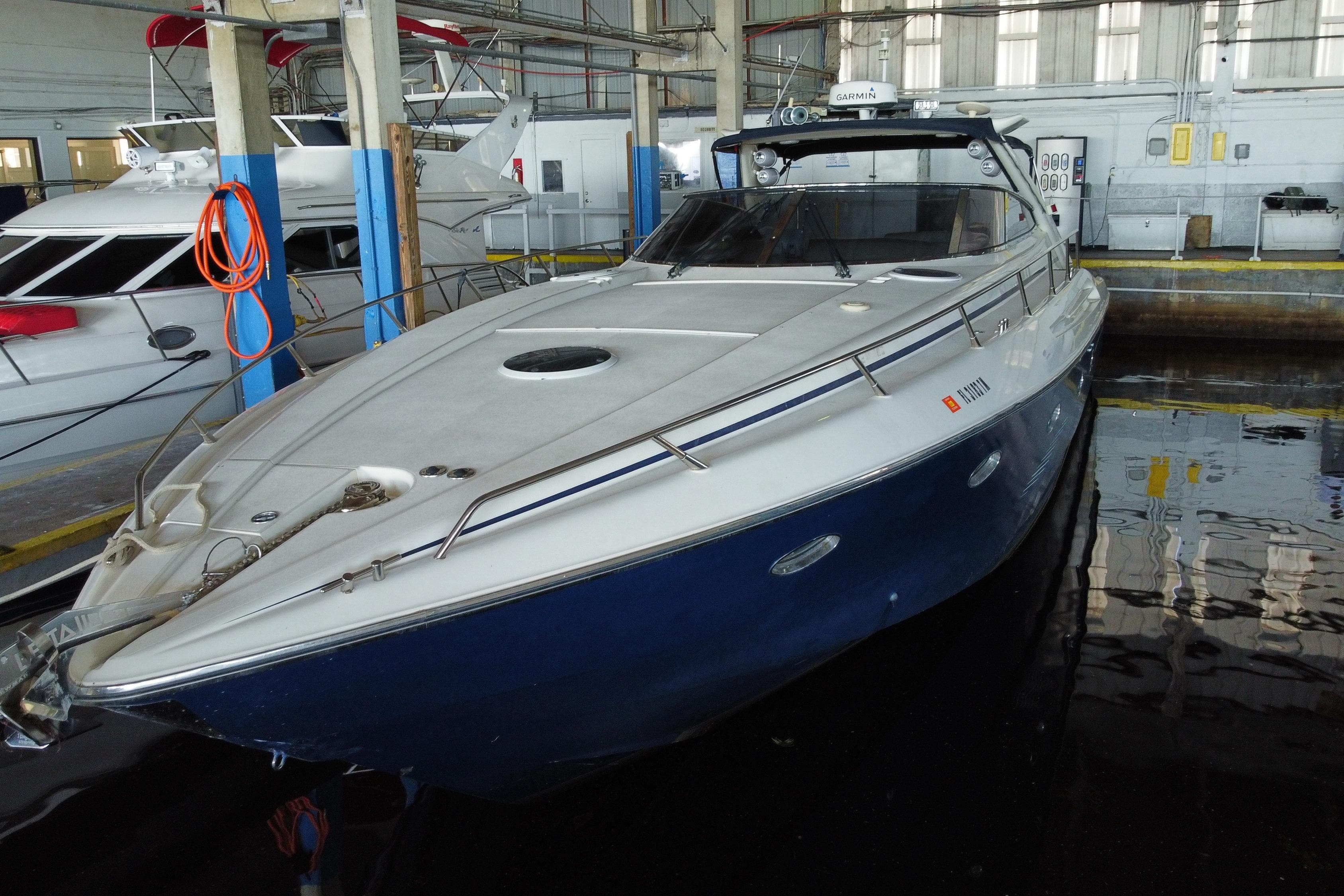 1997 Sunseeker Camargue 51 yacht docked in a marina.