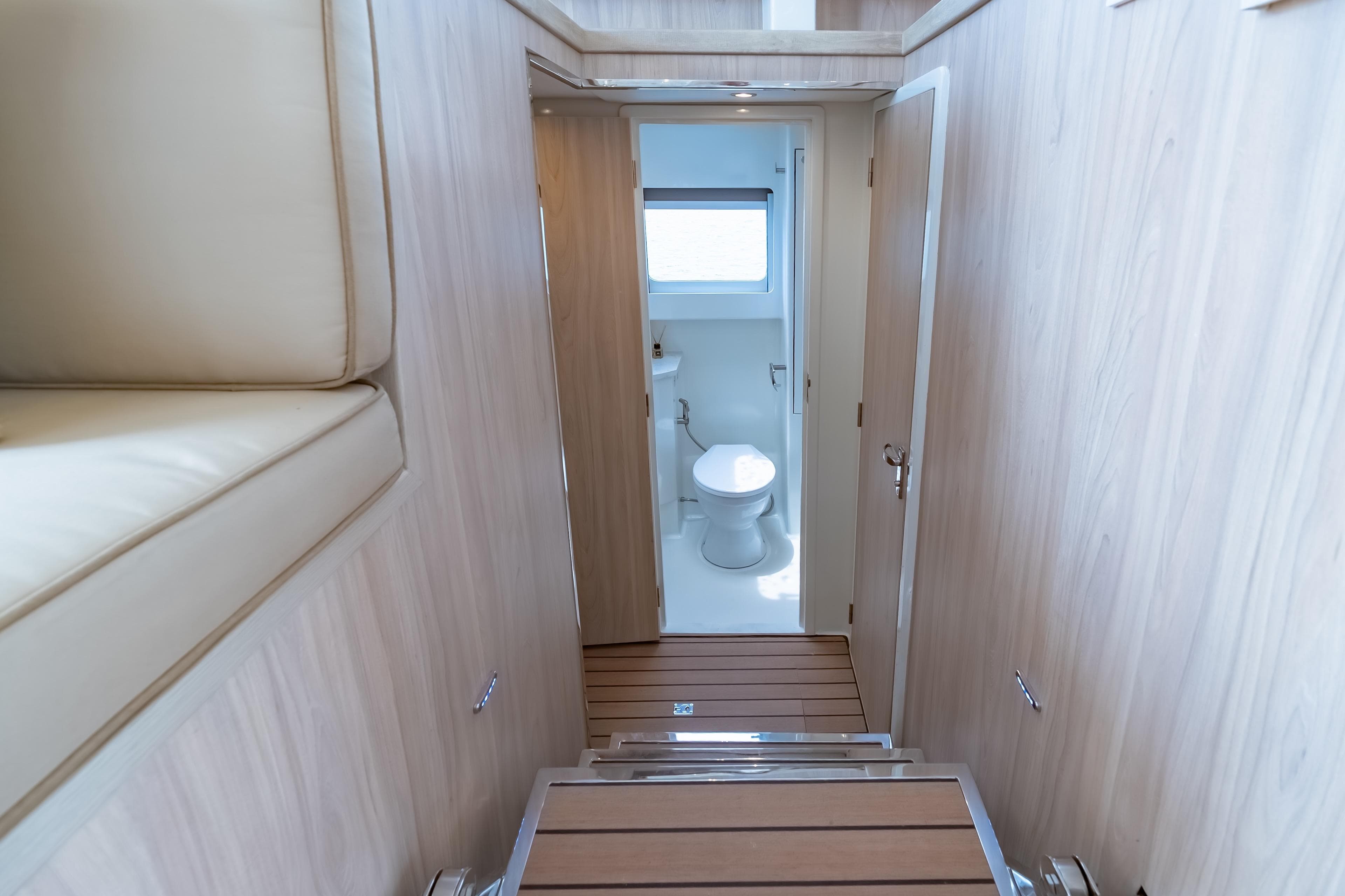 Interior of 2026 Island Spirit 525E yacht, featuring a modern bathroom and wooden finishes.