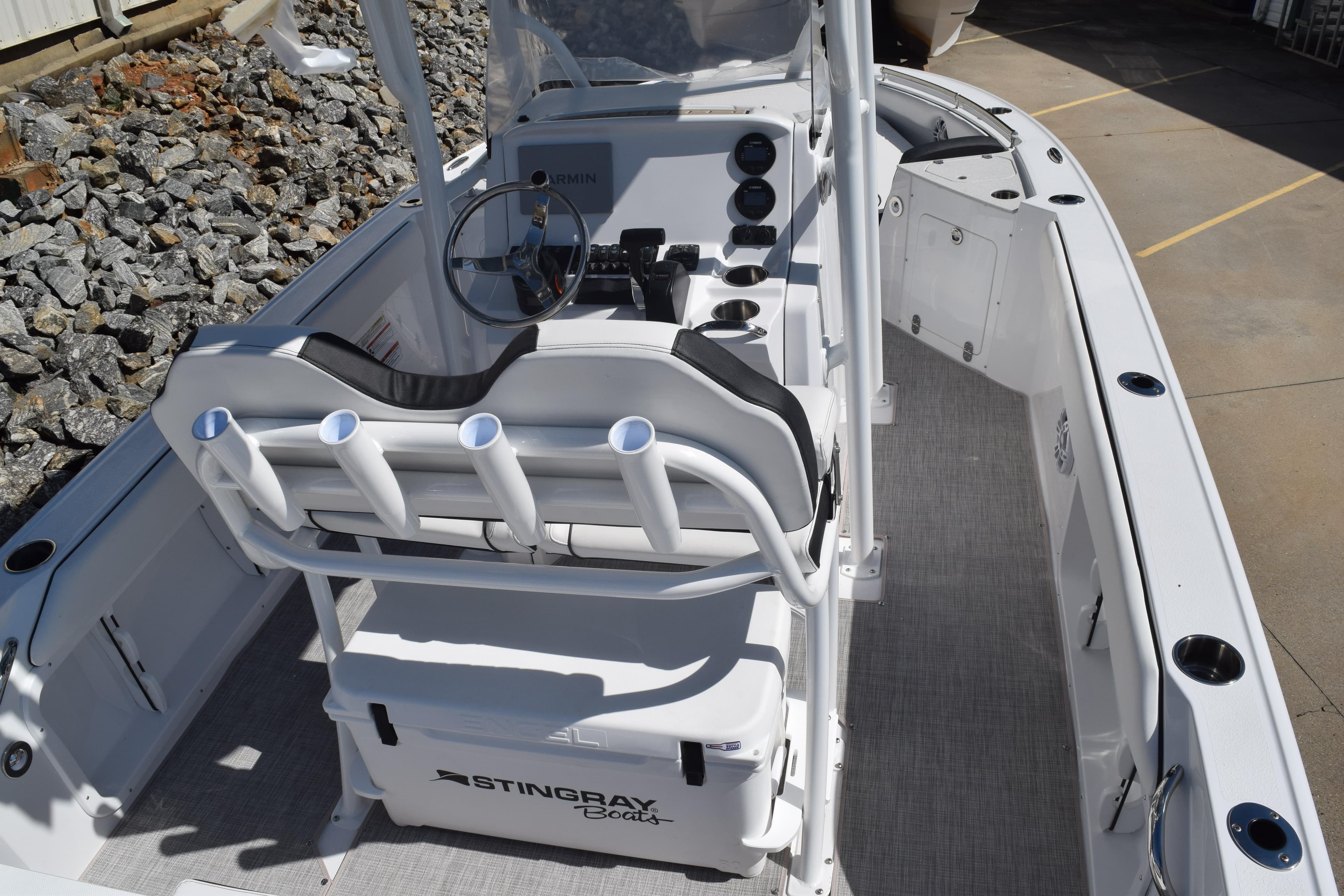 2025 Stingray 216CC boat interior with console and seating, featuring rod holders and storage.