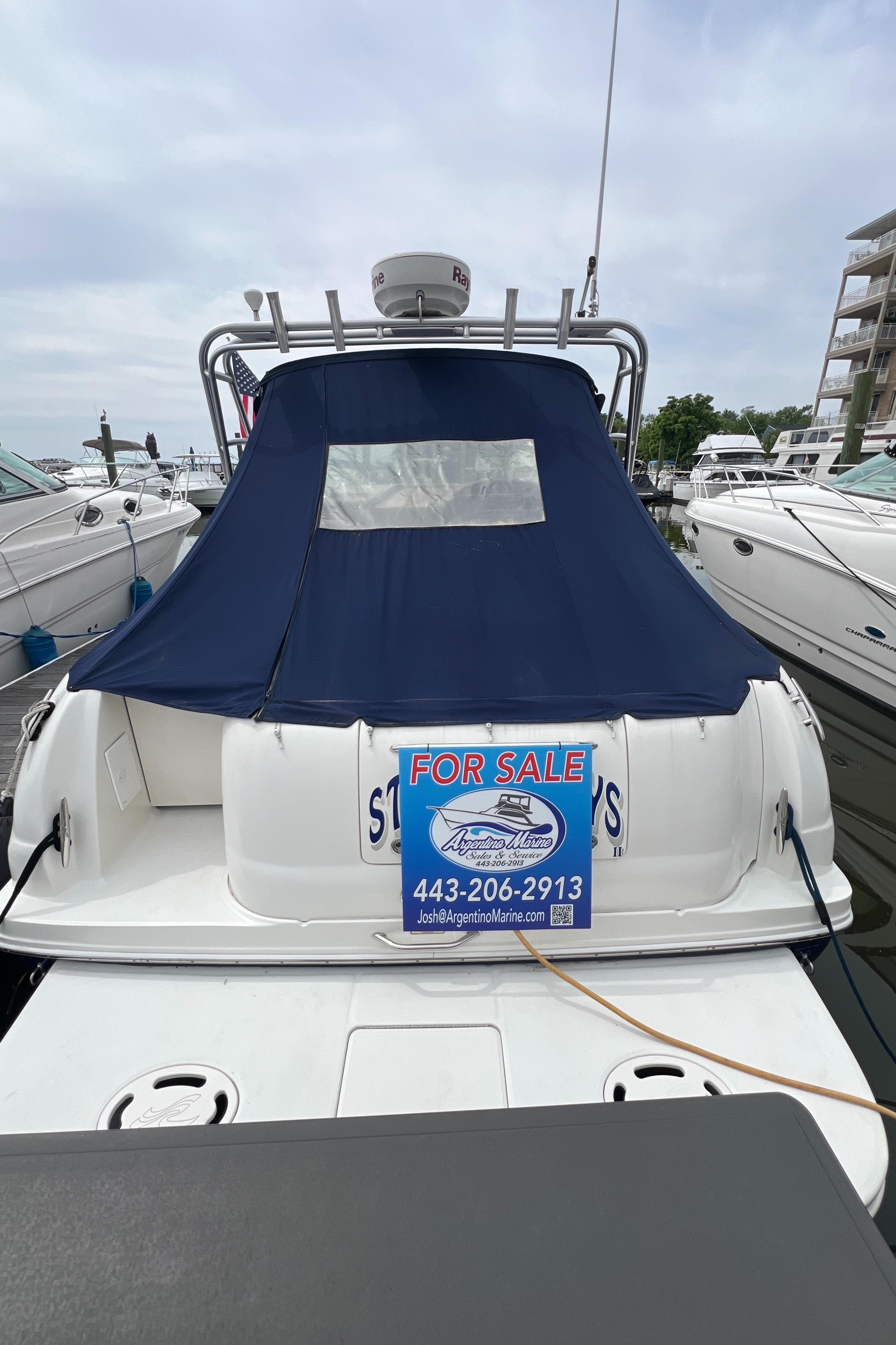 2005 Sea Ray 290 Amberjack boat for sale, docked with blue cover and contact information.