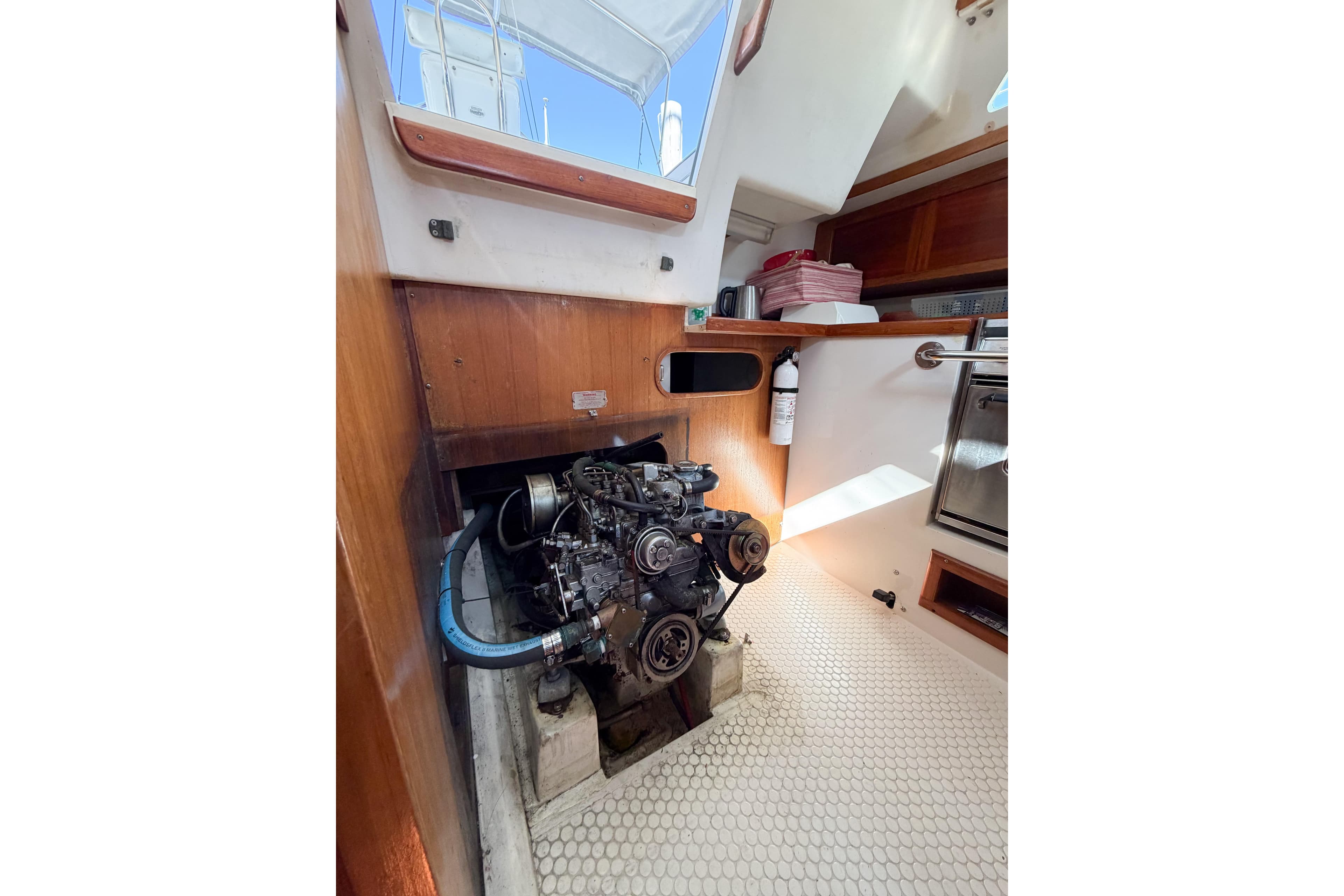 Engine compartment of a 1996 Catalina 36 MkII sailboat, showcasing interior details.