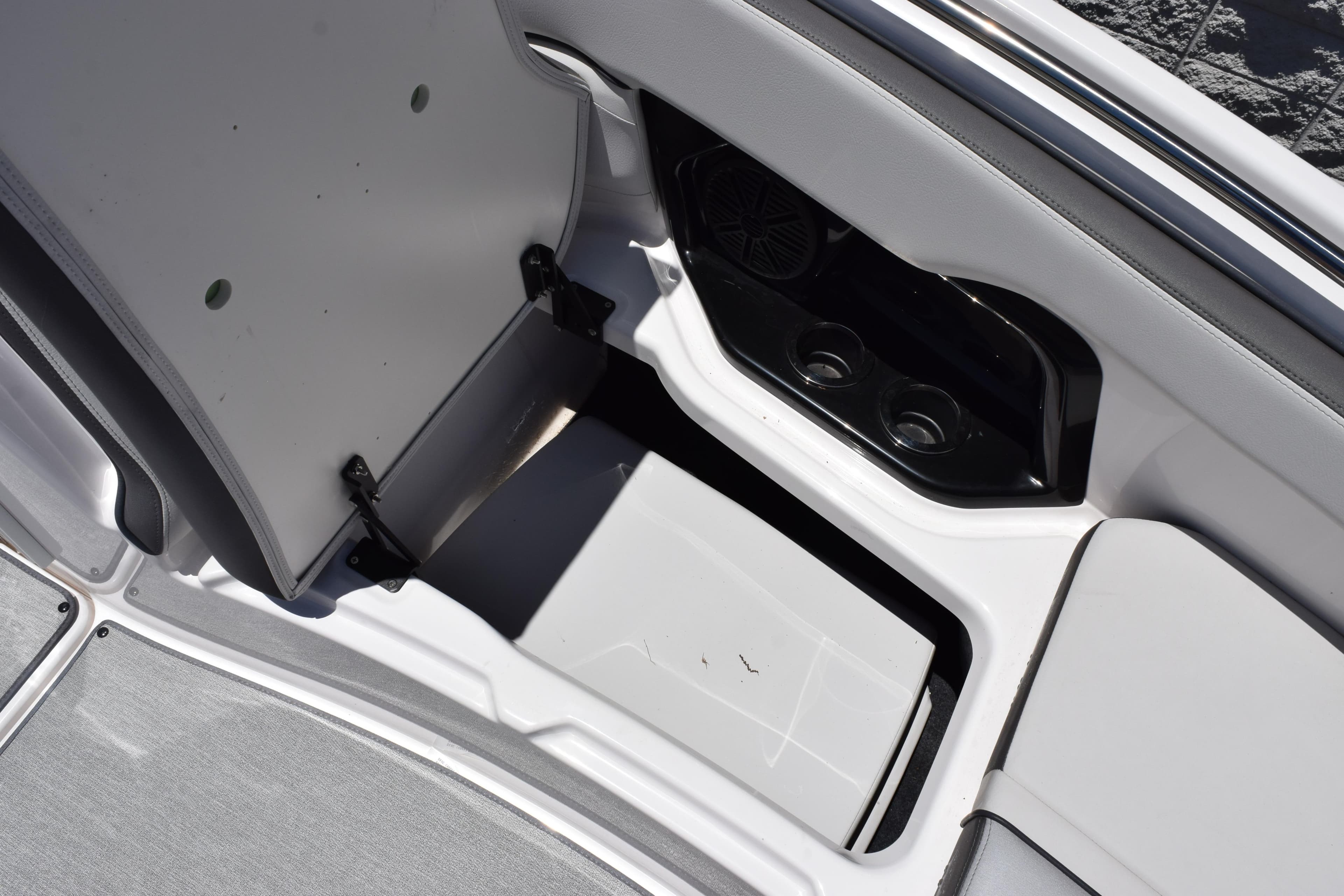 2023 Yamaha Boats SX250 interior storage compartment with cup holders and speaker.