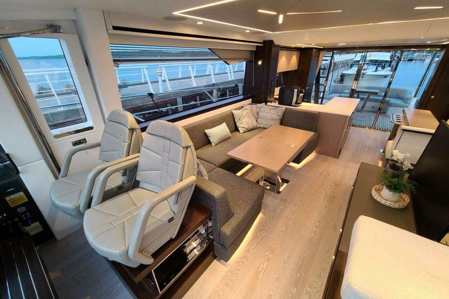 Luxurious interior of 2023 Sunseeker Manhattan 68 yacht with modern seating and elegant decor.