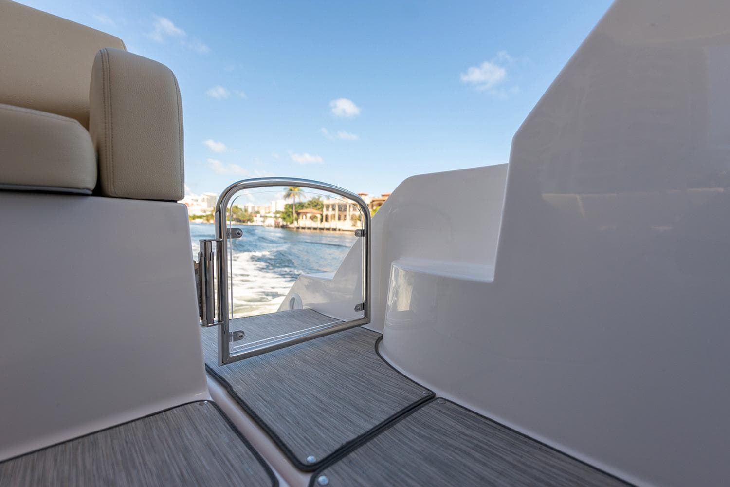Manufacturer Provided Image: 2022 Regal 38 Grande Coupe yacht, rear deck view with water and sky background.