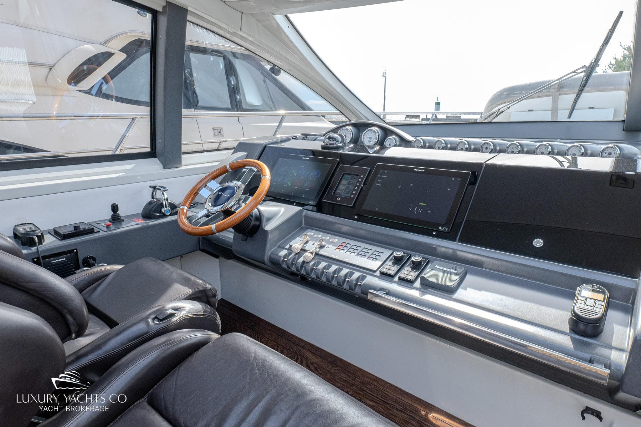 Luxurious 2010 Azimut 62S yacht helm with modern controls and leather seating.