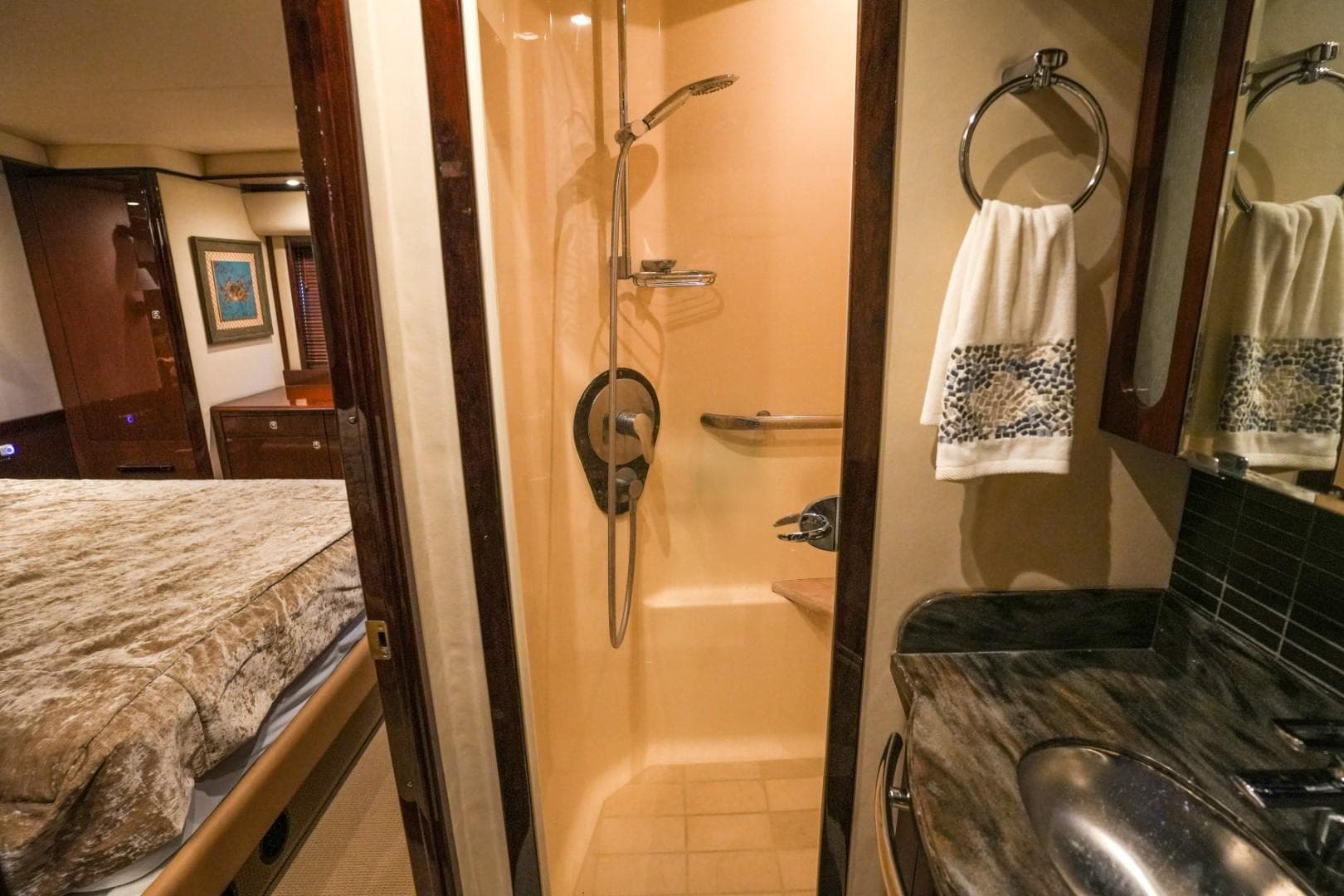 Luxurious bathroom in 2013 Sea Ray 610 Sundancer yacht, featuring shower and elegant sink area.