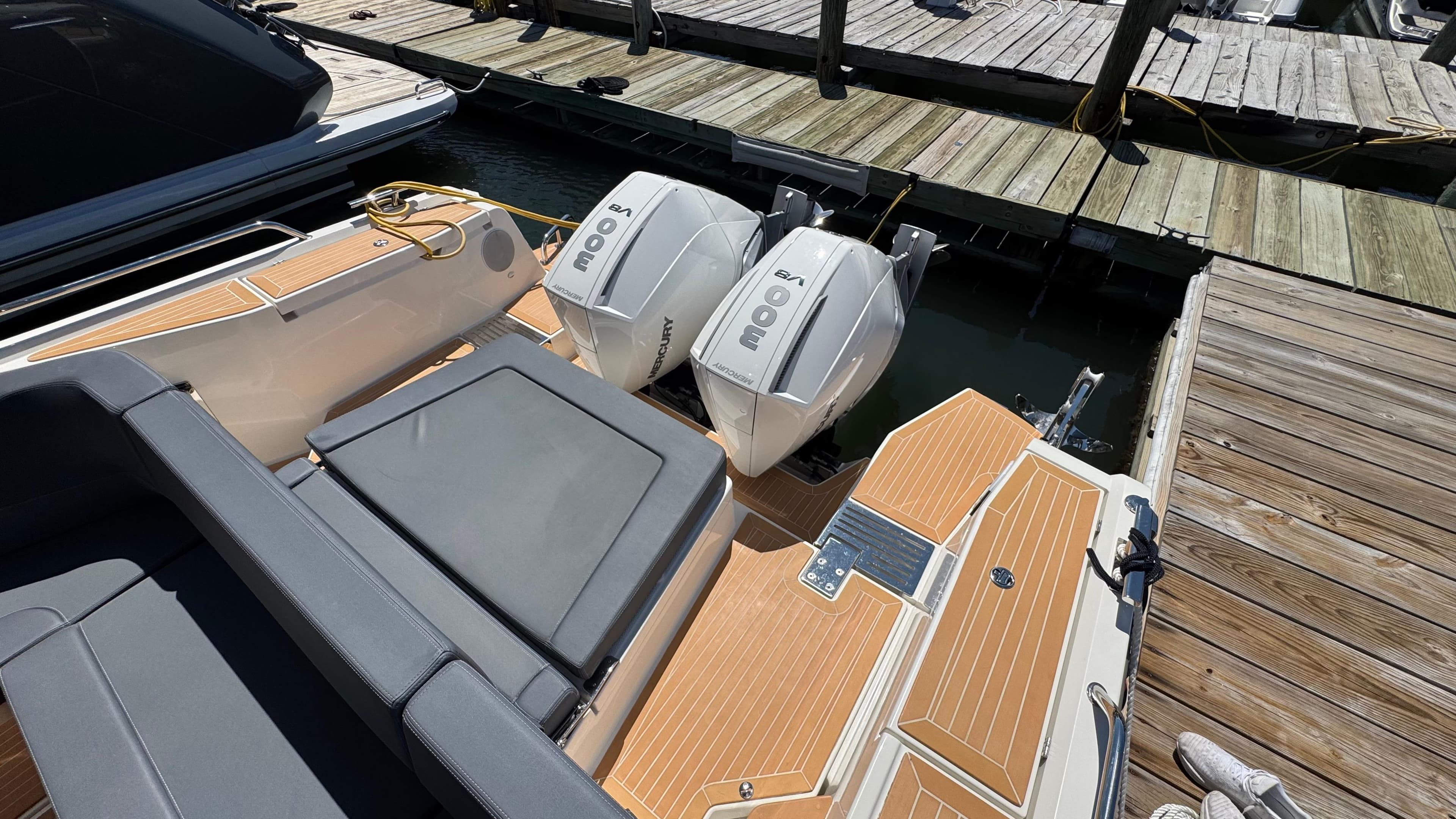 2024 Nimbus W11 boat with twin outboard engines docked at a marina.