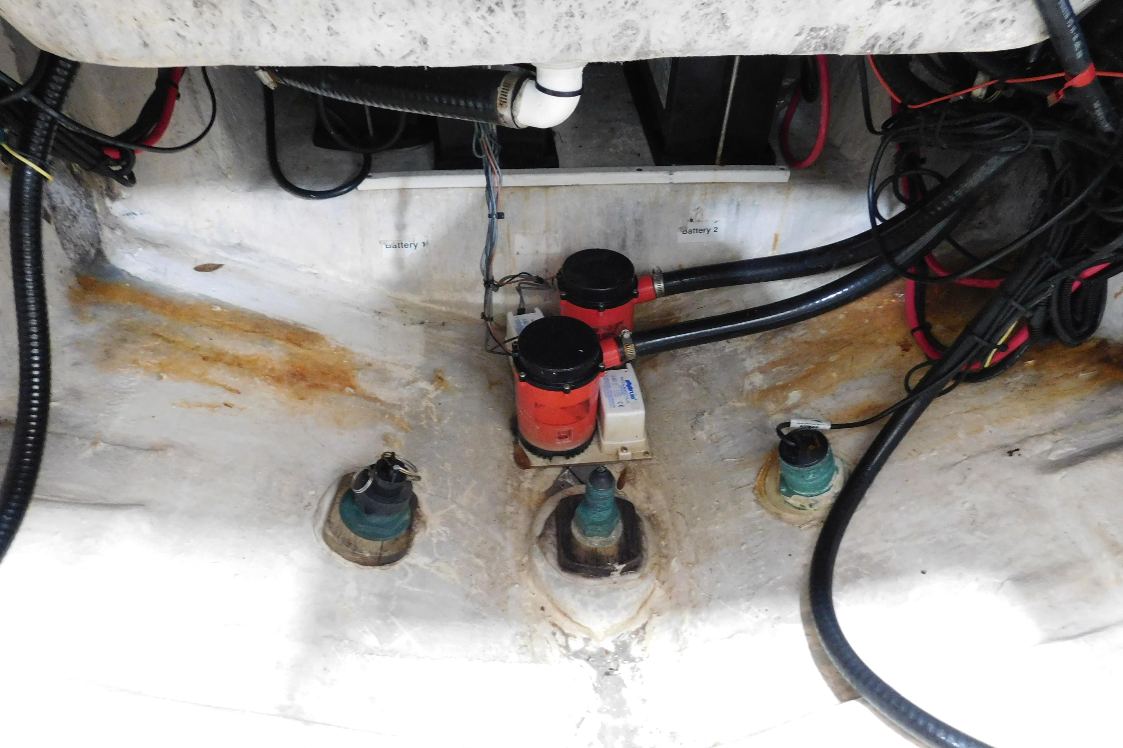 2003 Regulator 32 Center Console bilge area with wiring and pumps.