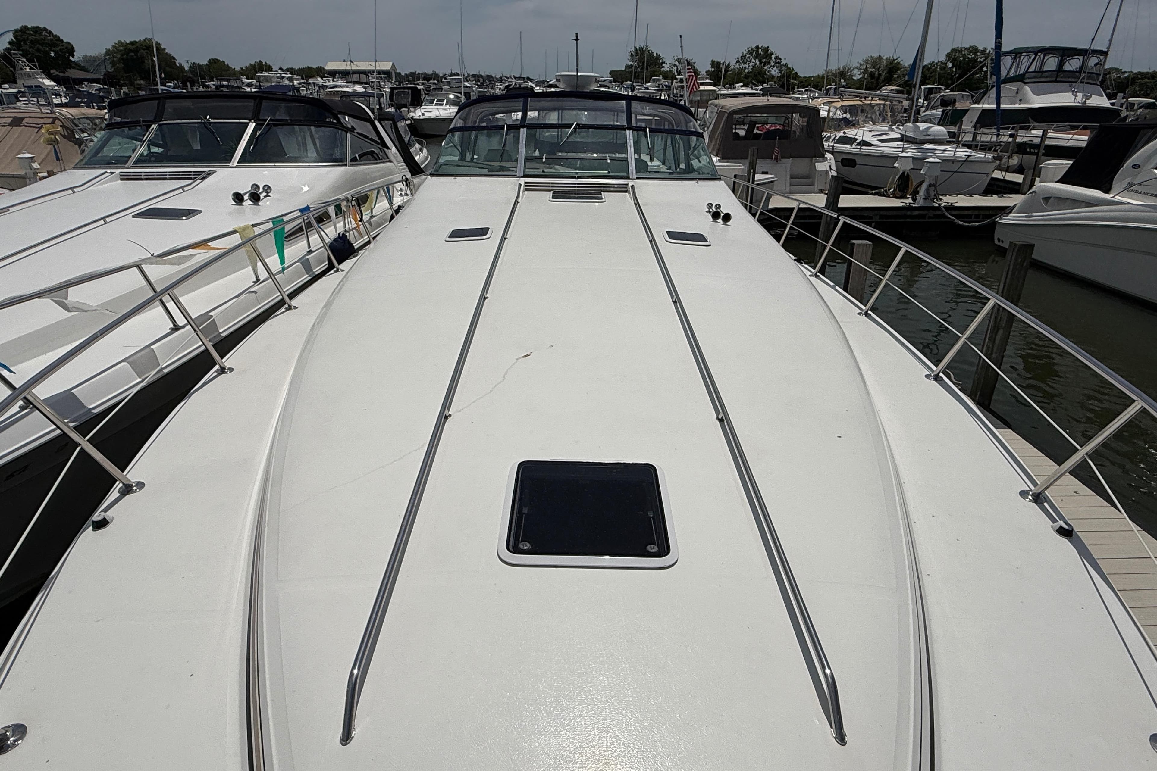 1998 Sea Ray 500 Sundancer yacht docked at marina, showcasing sleek deck design.