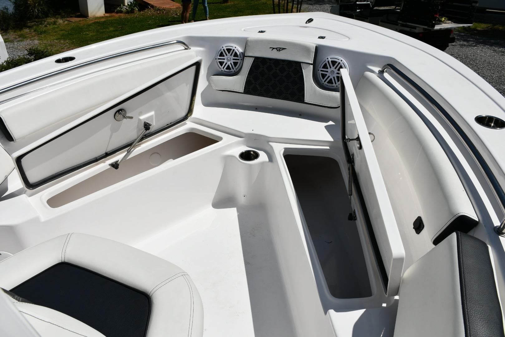 2023 Tidewater 210 LXF boat interior with open storage compartments and seating.