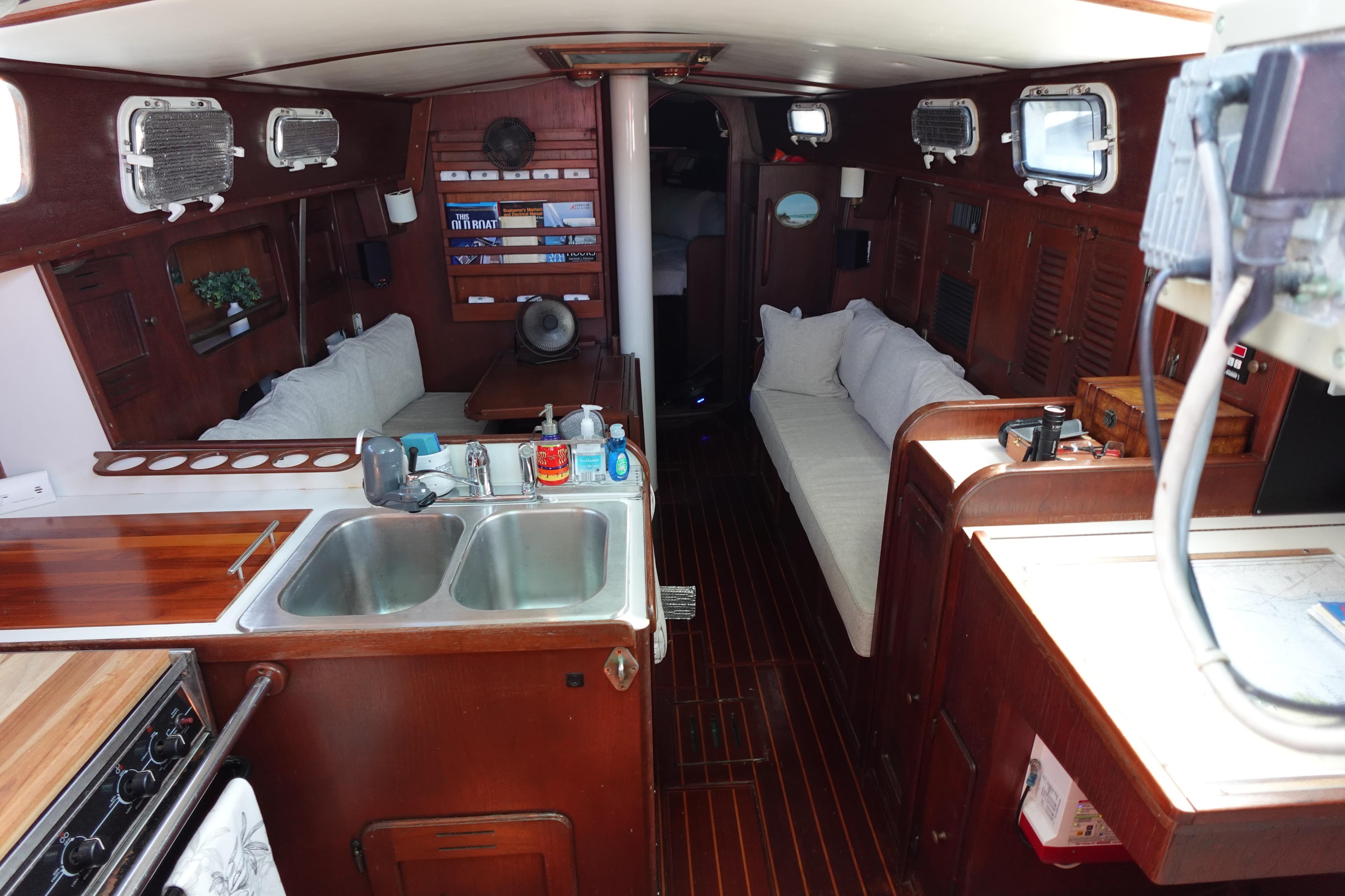 1978 Morgan 382 yacht interior with wooden finish, kitchen, and seating area.