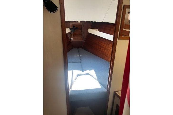 Interior cabin of 1982 Tartan 33 sailboat with cozy sleeping area.