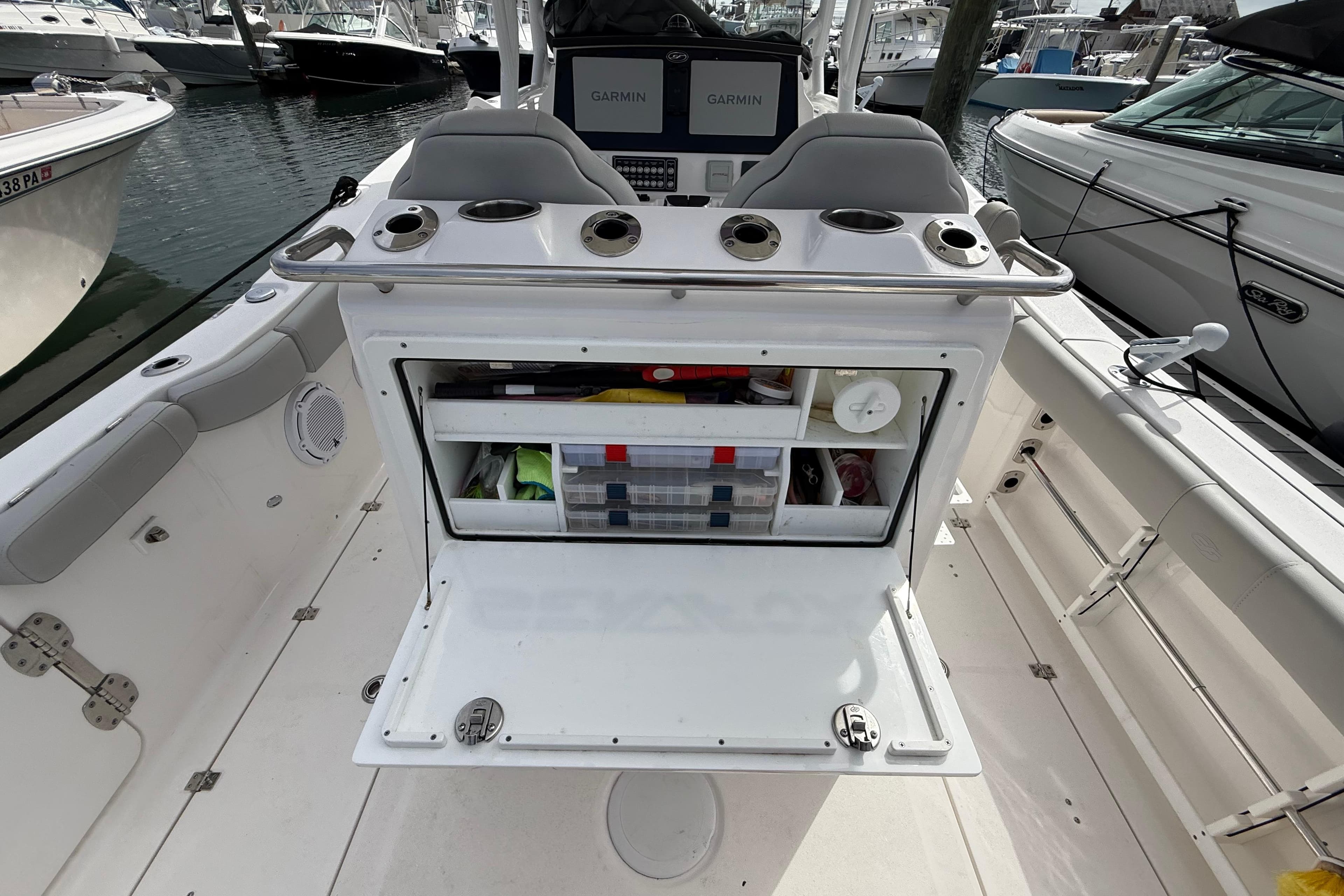 2021 Sea Fox 288 Commander boat interior with open storage compartment and Garmin displays.