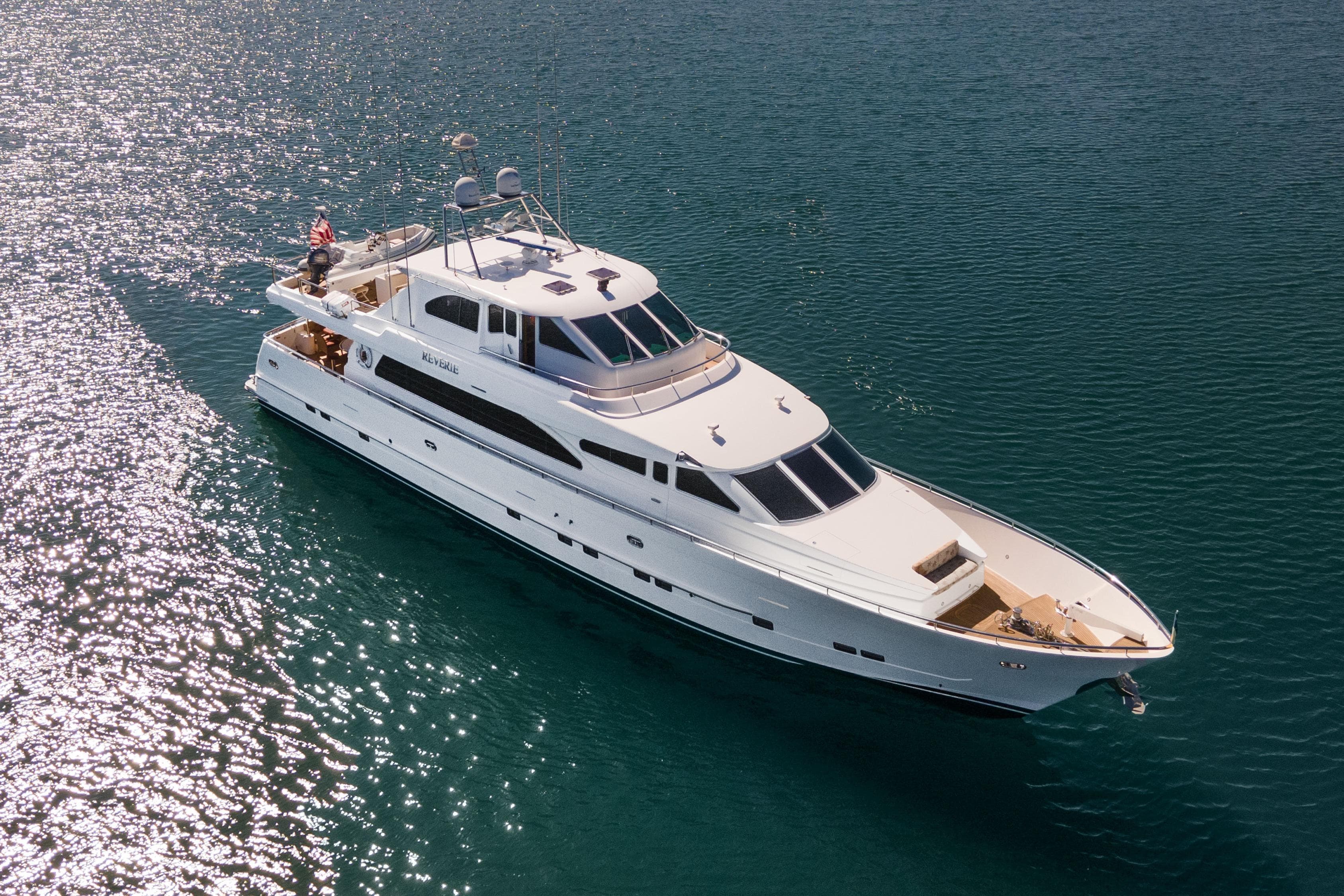 Luxurious 2005 Custom yacht cruising on sparkling blue water.