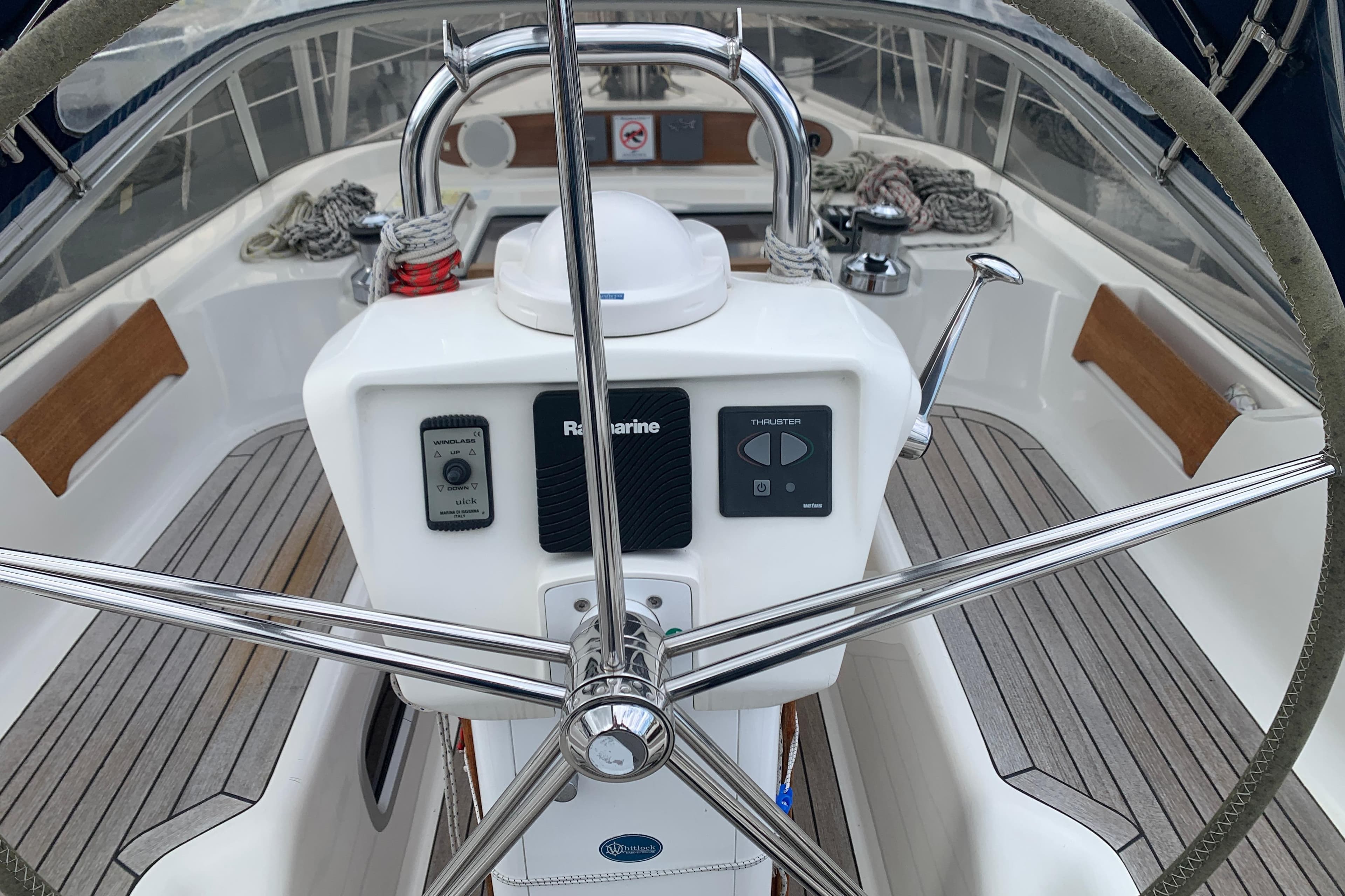 Steering wheel and controls of a 2000 Sunbeam 37 sailboat cockpit.