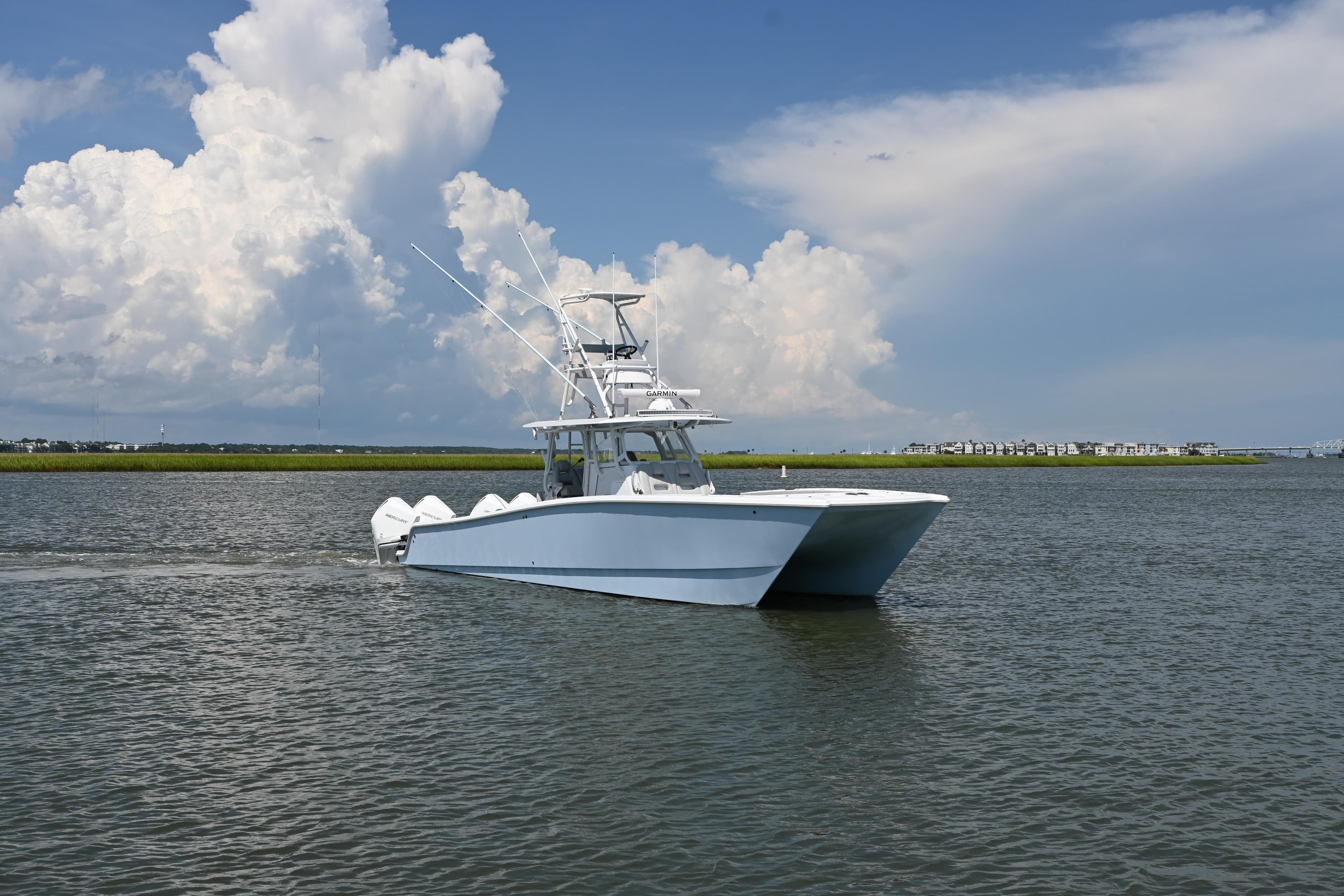 Freeman 37VH 2021 boat cruising on a calm waterway under a cloudy sky.