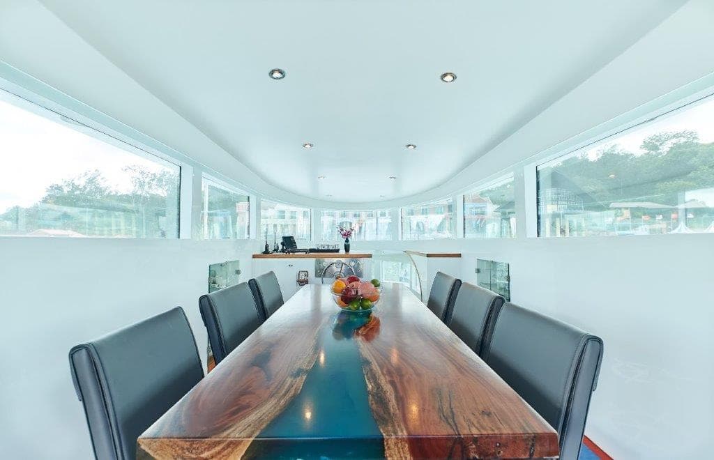 Luxurious Bondway EX-11 yacht interior with elegant dining area, wooden table, and panoramic windows.