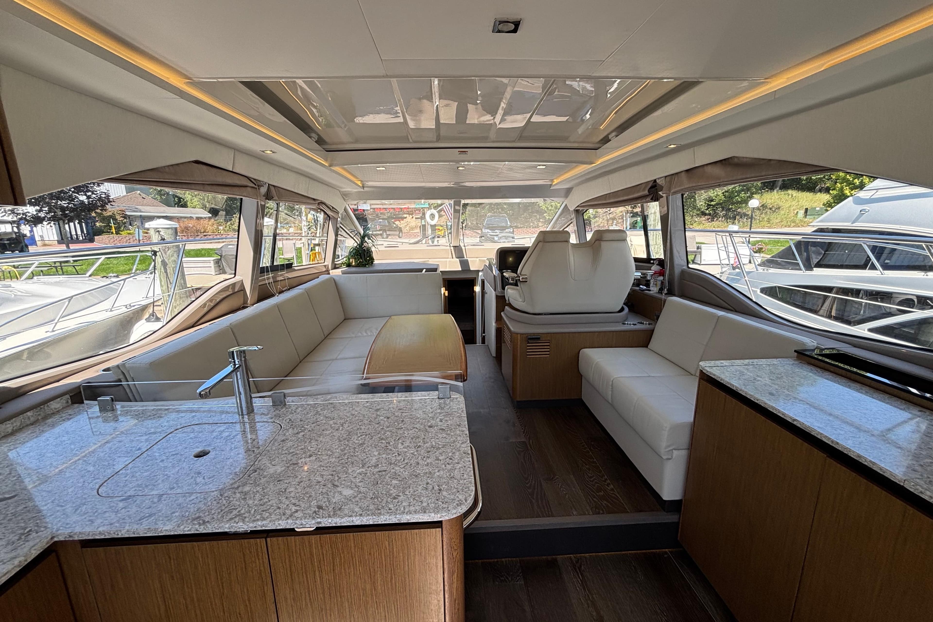 Luxurious interior of 2018 Sea Ray Sundancer 460 yacht with modern seating and kitchen area.