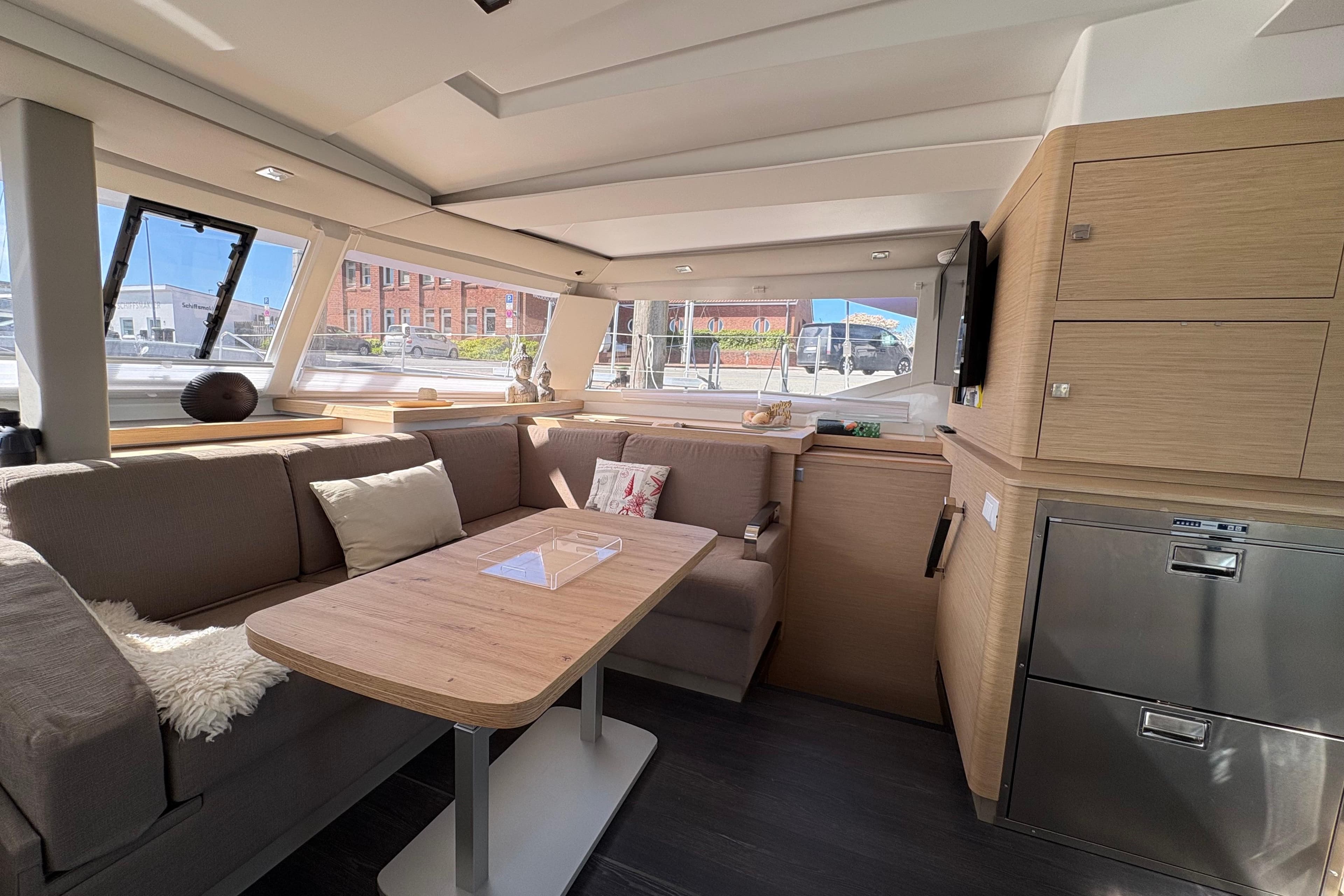 Modern interior of 2024 Fountaine Pajot Astrea 42 Catamaran with cozy seating and elegant design.