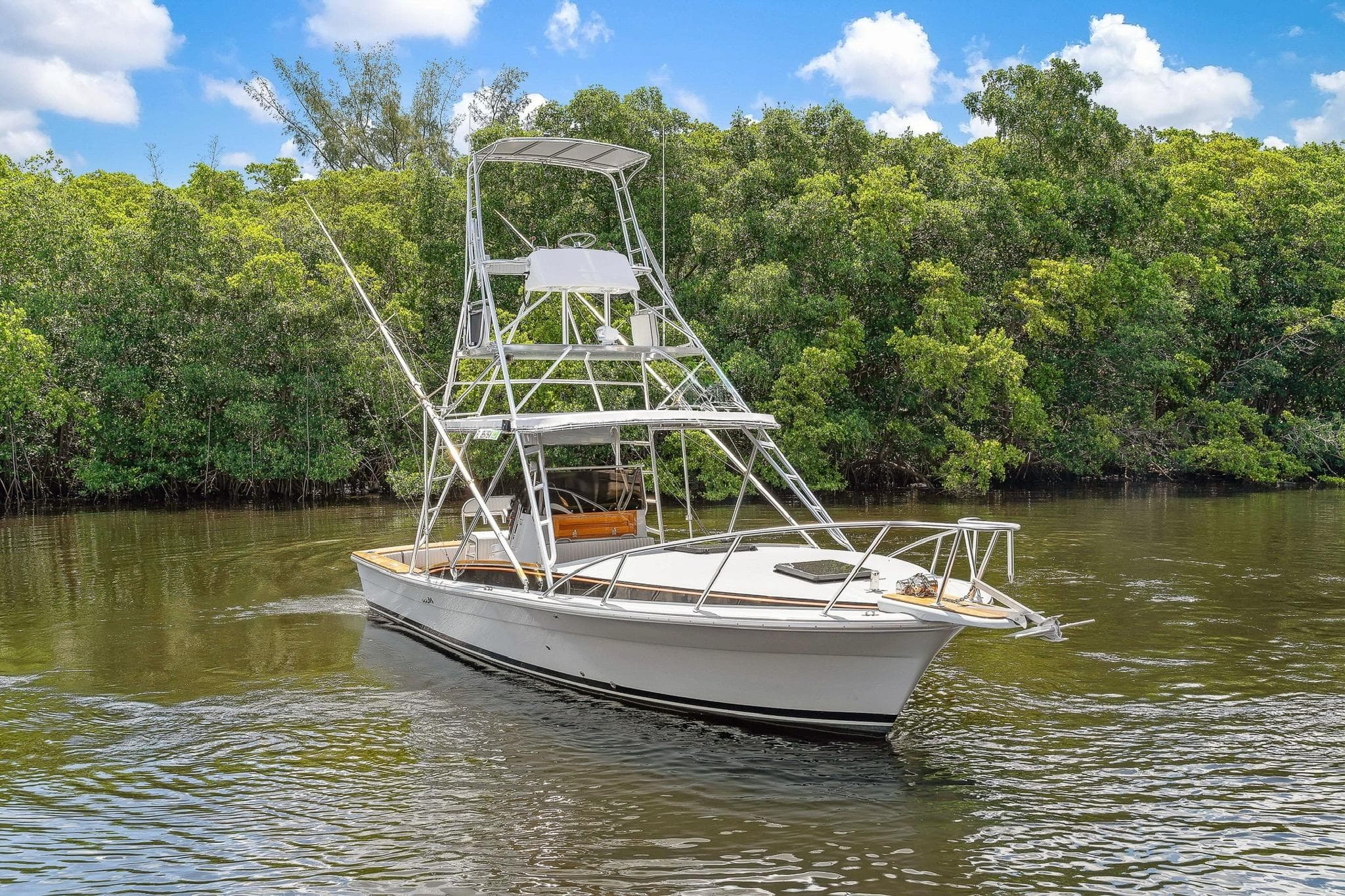 2024 Strike 29' Center Console boat with cuddy, cruising on a serene river.