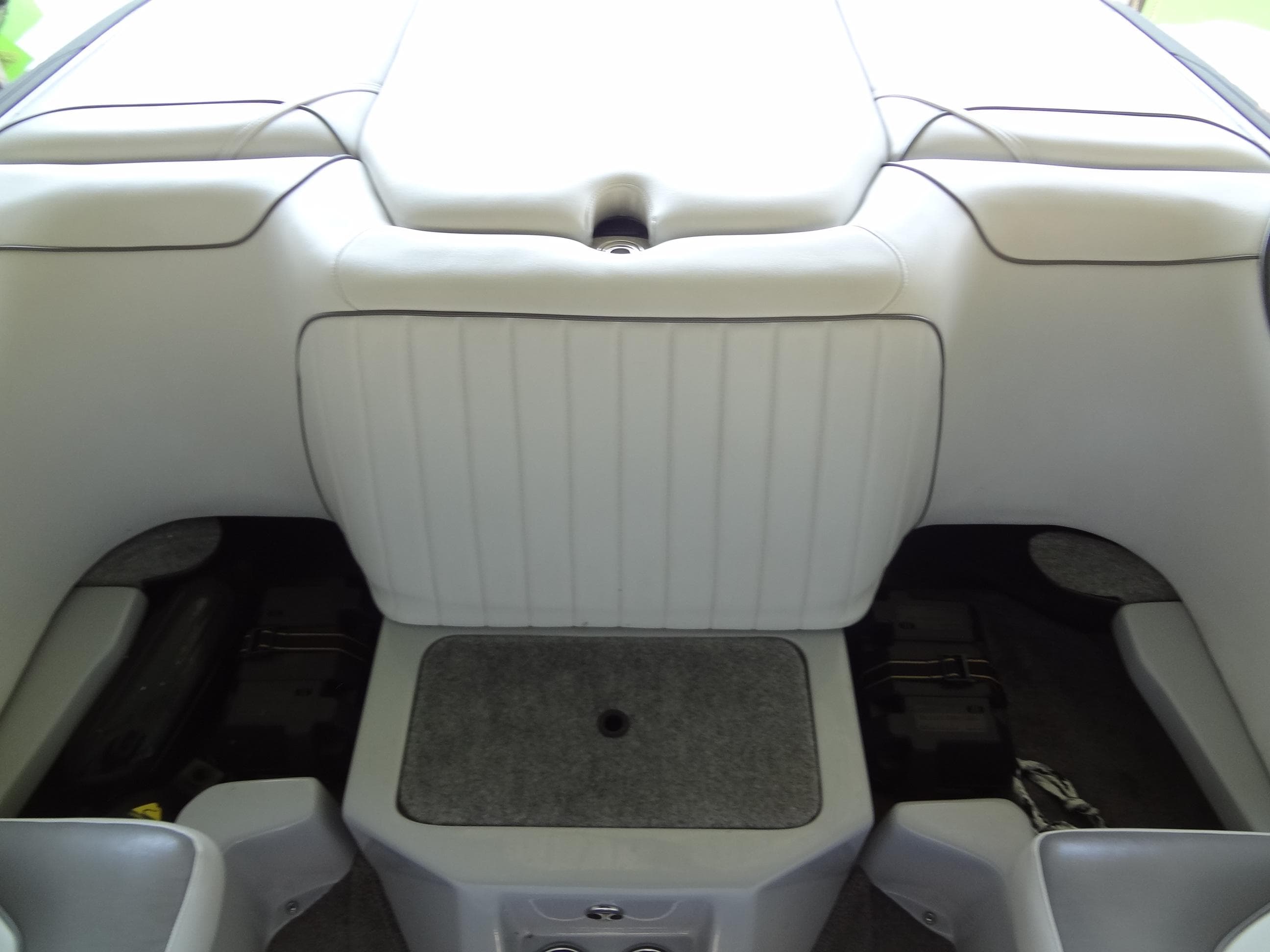 2022 Sanger V237 S boat interior, featuring sleek white seating and storage compartments.