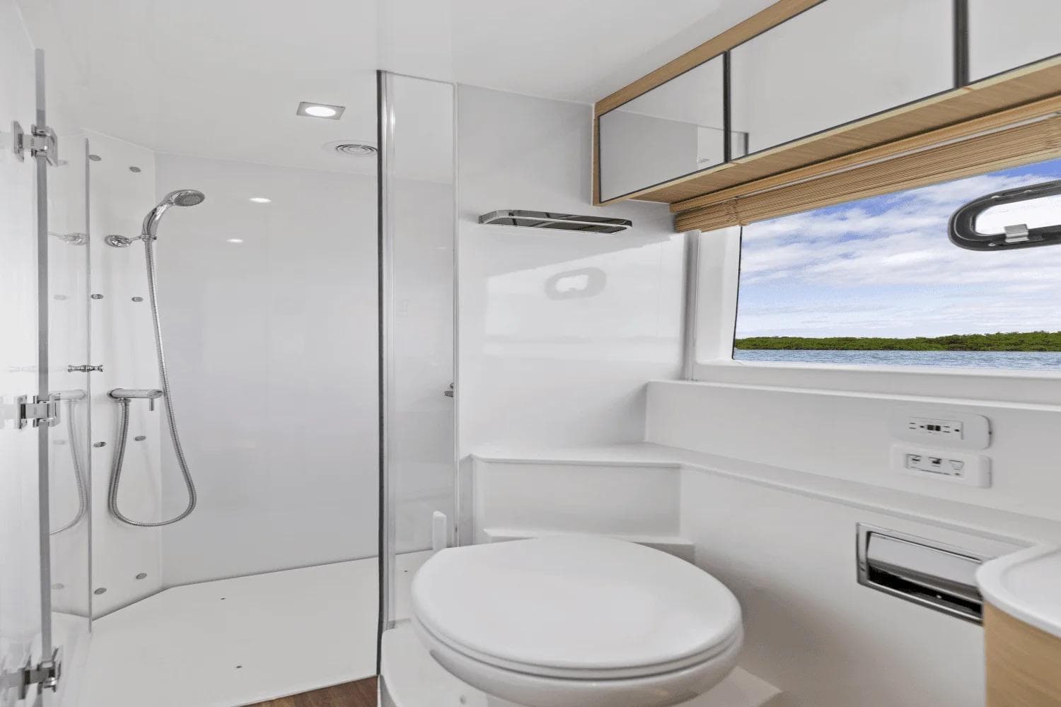 Luxurious bathroom in 2026 Aquila 50 Yacht with modern shower and scenic window view.