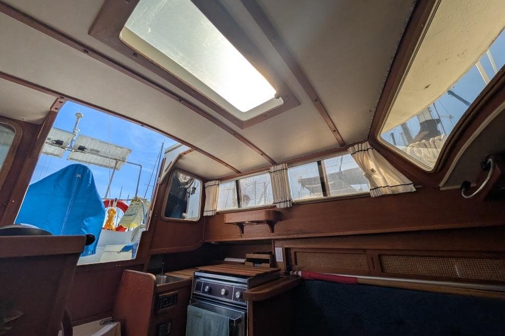 Interior of a 1986 Gulf Pilothouse boat with wooden finishes and skylight.