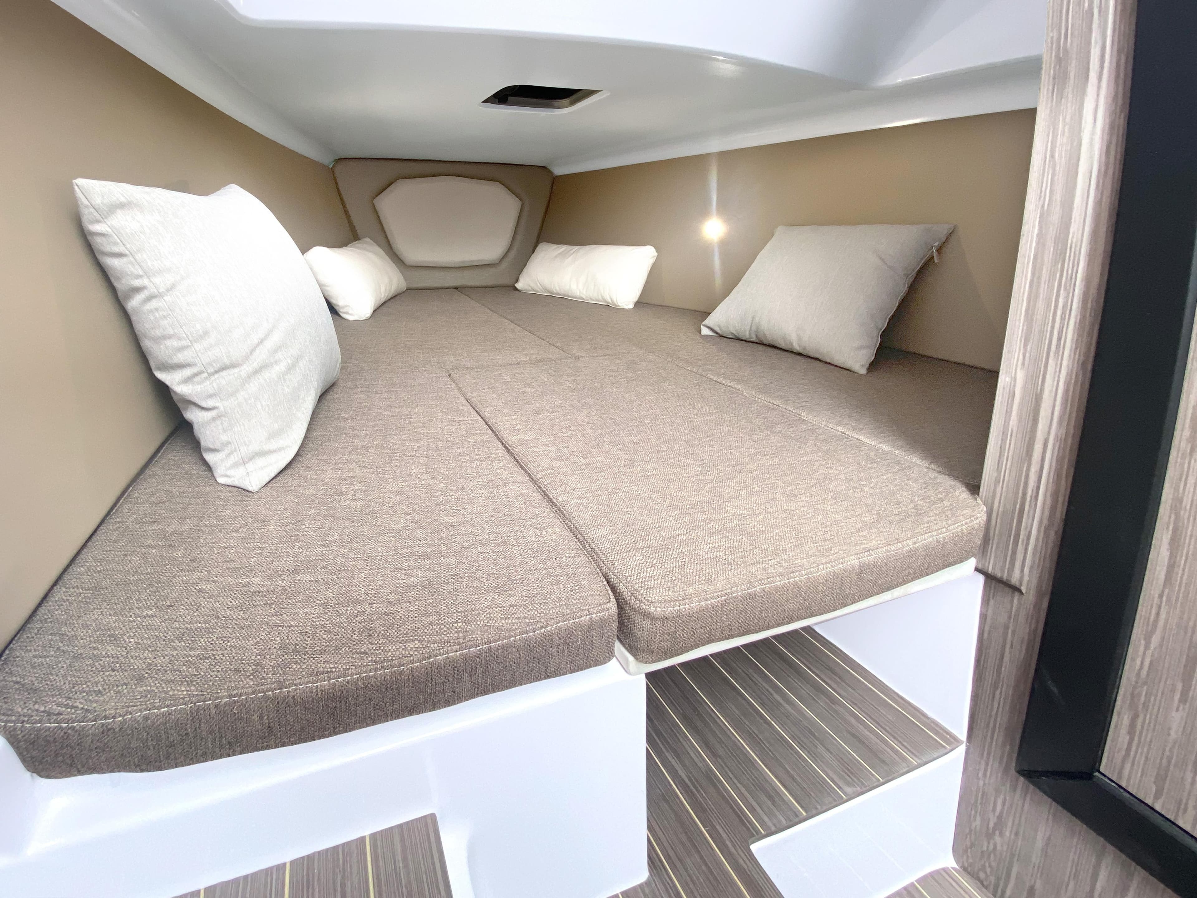 2025 Ranieri CAYMAN 28 EXECUTIVE cabin interior with cushioned bed and pillows.