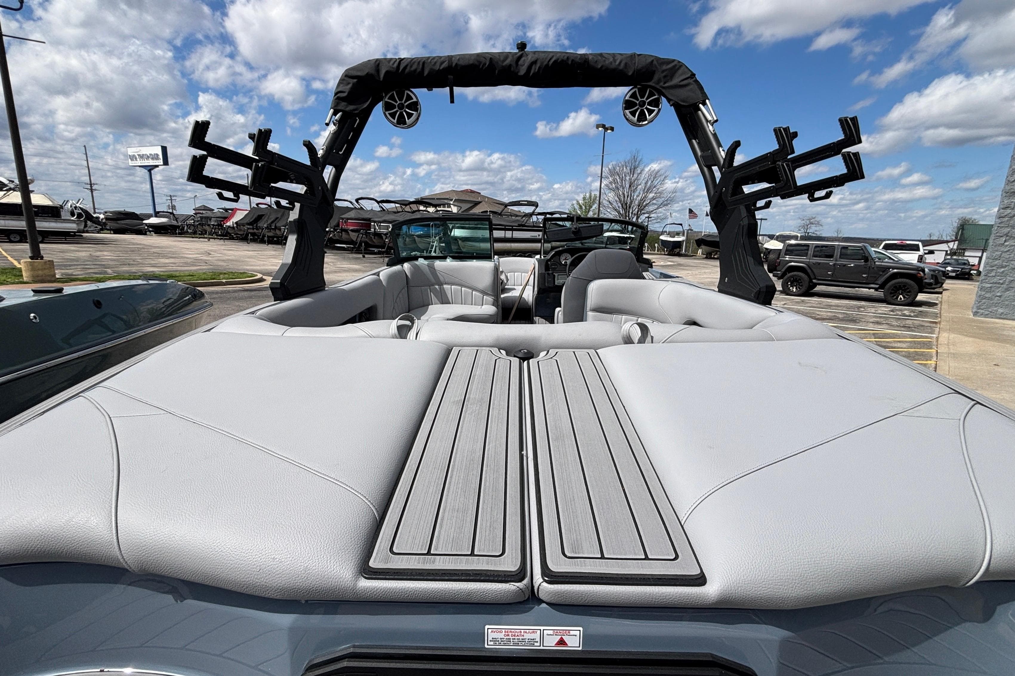 2026 MB B52 23 Classic boat interior with gray seating and wakeboard racks.