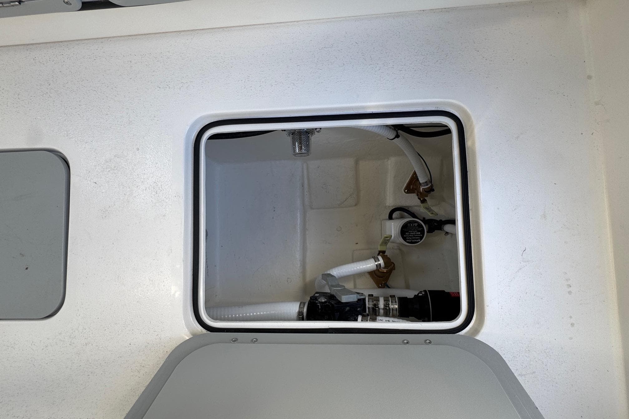 2026 Defiance Admiral 250 EX boat compartment with visible plumbing and wiring.