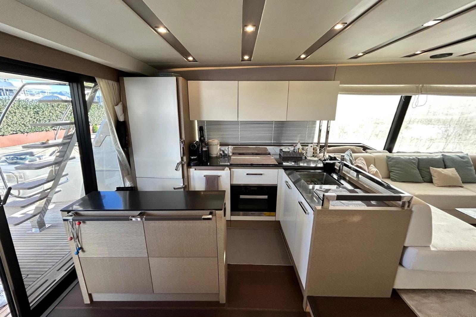 Luxurious kitchen interior of 2017 Prestige 680 yacht with modern design and ample seating.