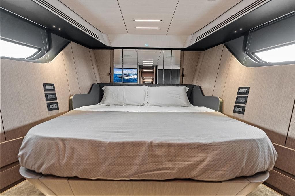 Luxurious bedroom interior of 2025 Pershing GTX 80 yacht with modern design and ambient lighting.