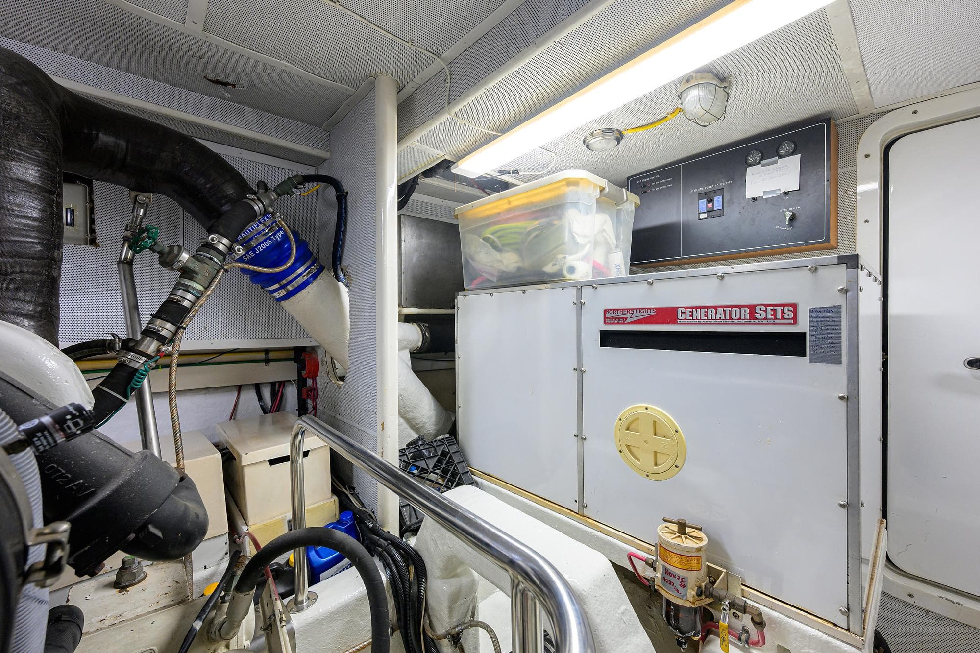 Engine room of 2001 Ocean Alexander 602 yacht with generator and equipment.