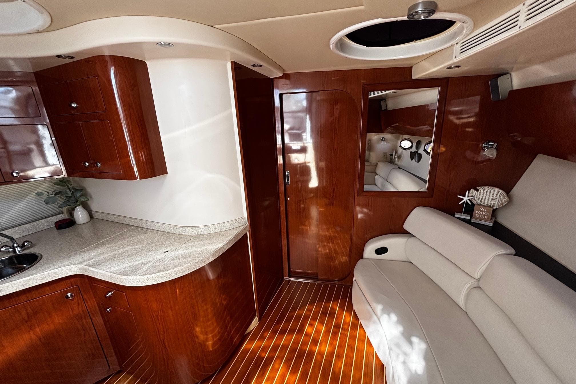 Luxurious interior of 2006 Regal Commodore 3860 yacht with wood finish and modern amenities.