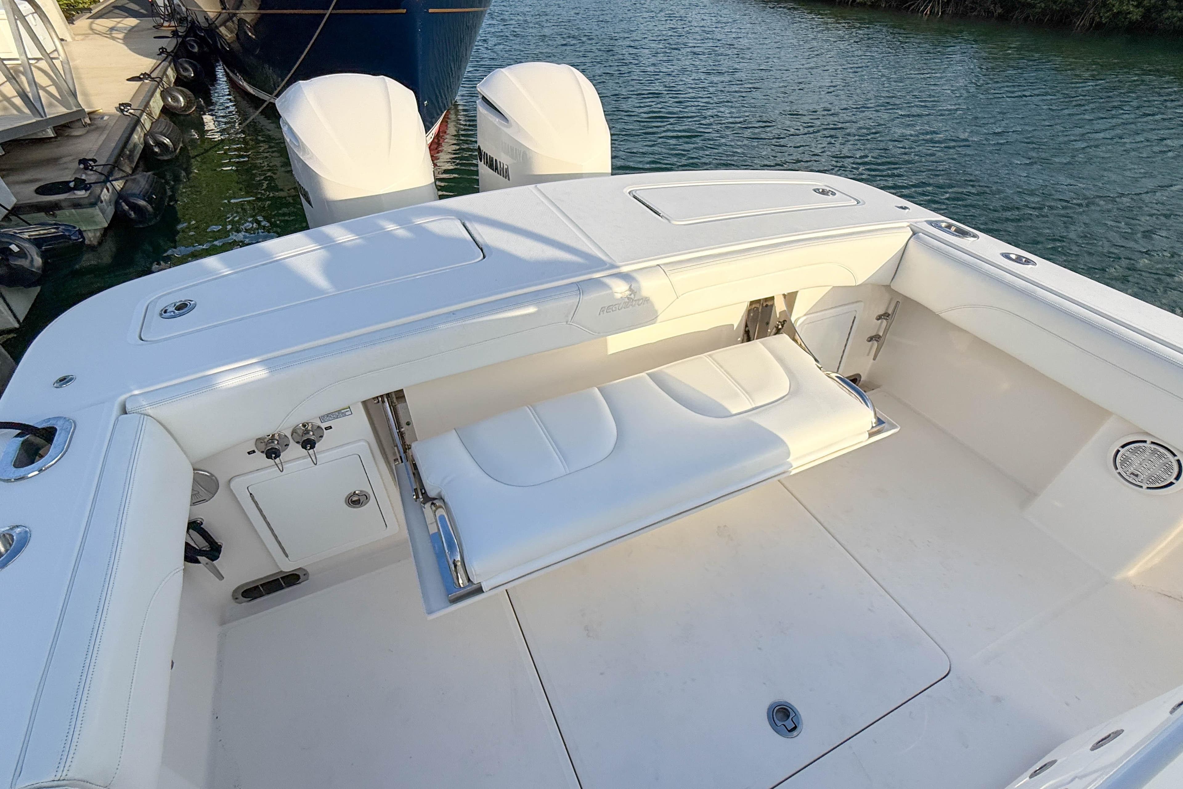 2020 Regulator 31 boat with white seating and dual outboard motors.