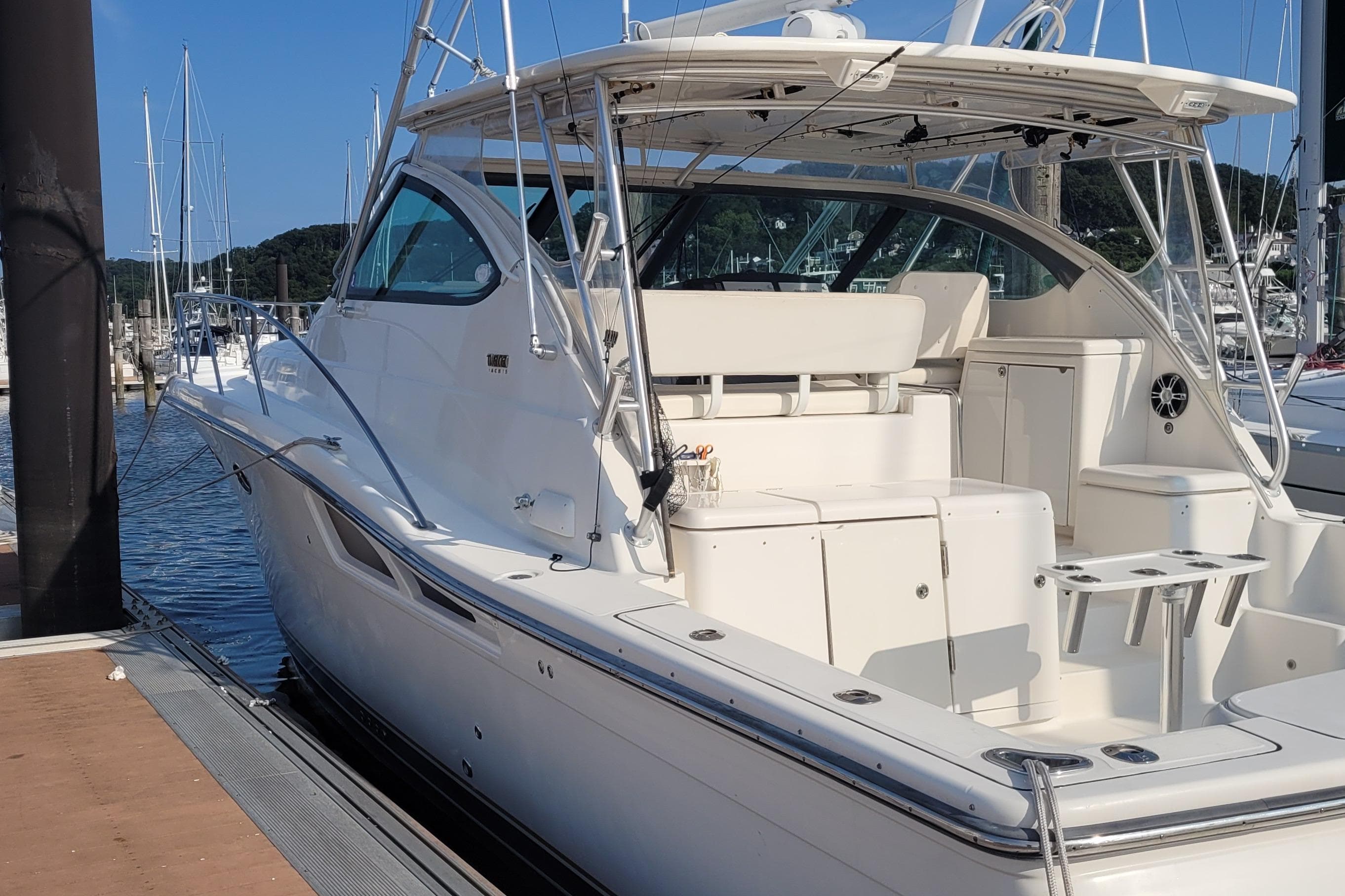 2006 Tiara Yachts 4200 Open docked at marina, showcasing sleek design and spacious deck.