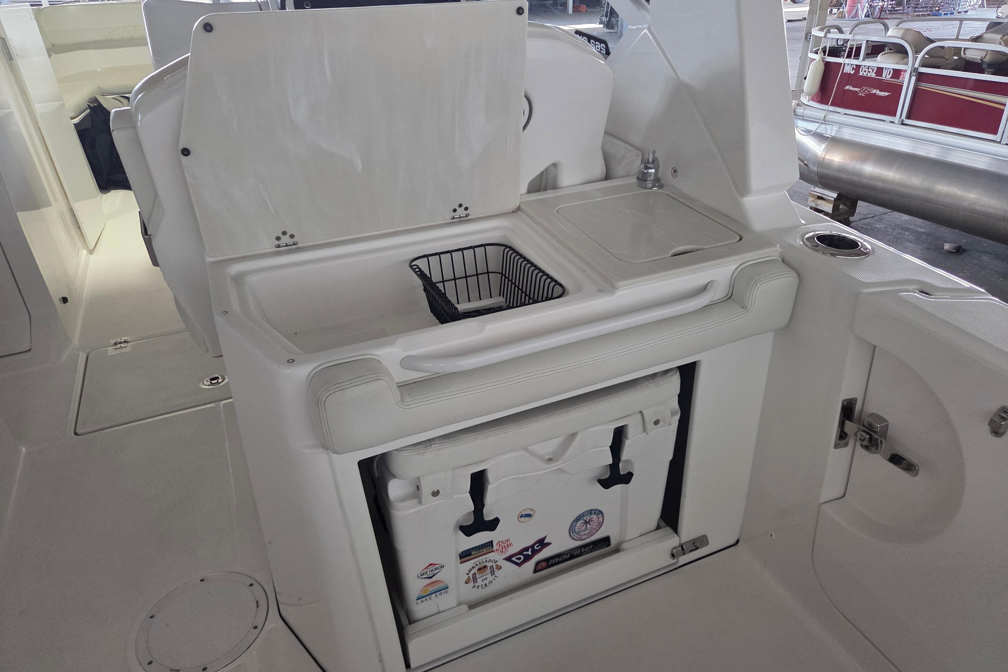 2019 Edgewater 262CX Crossover boat interior with sink and storage area.