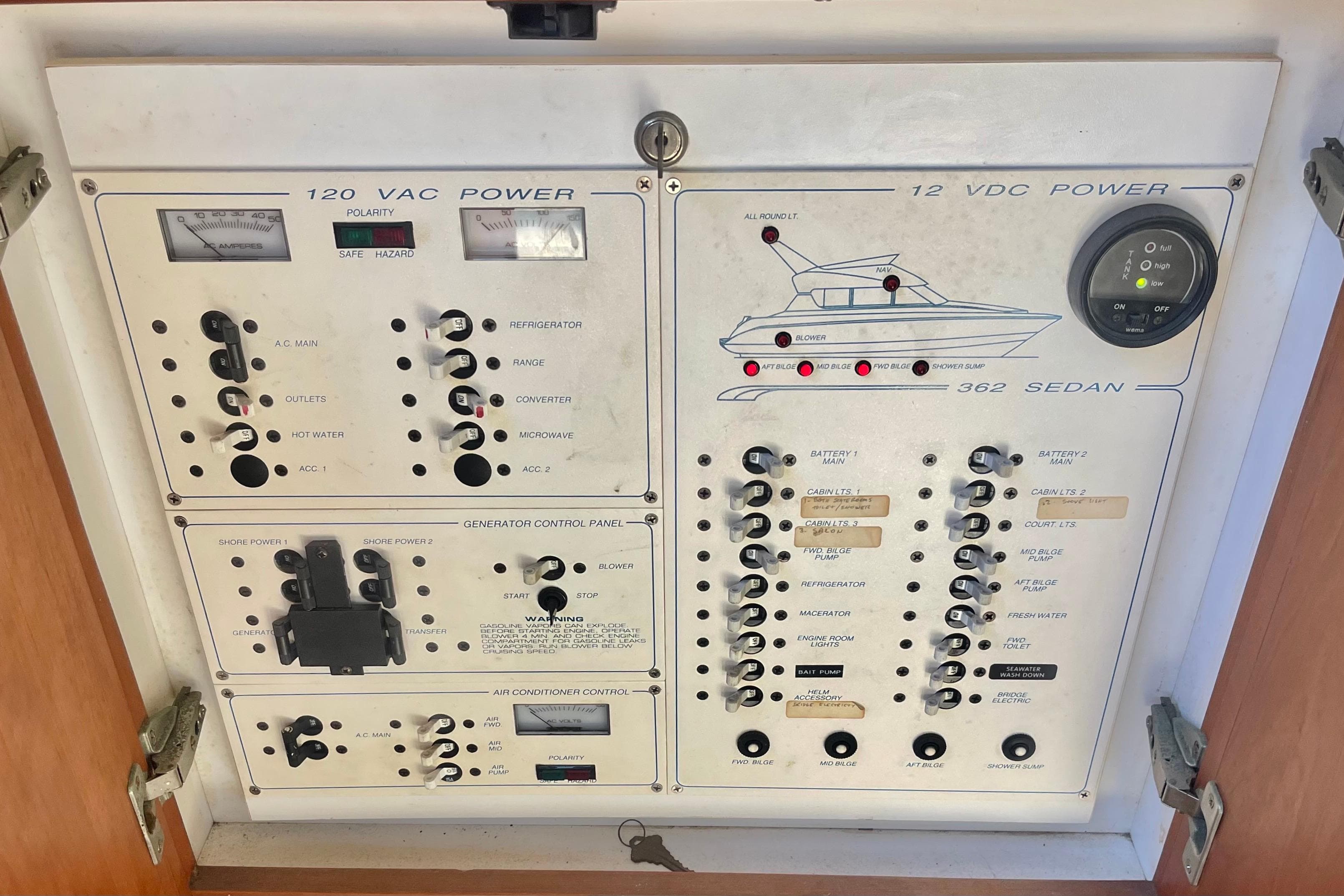 Electrical control panel of a 1995 Silverton 36 Convertible boat, featuring various switches and gauges.