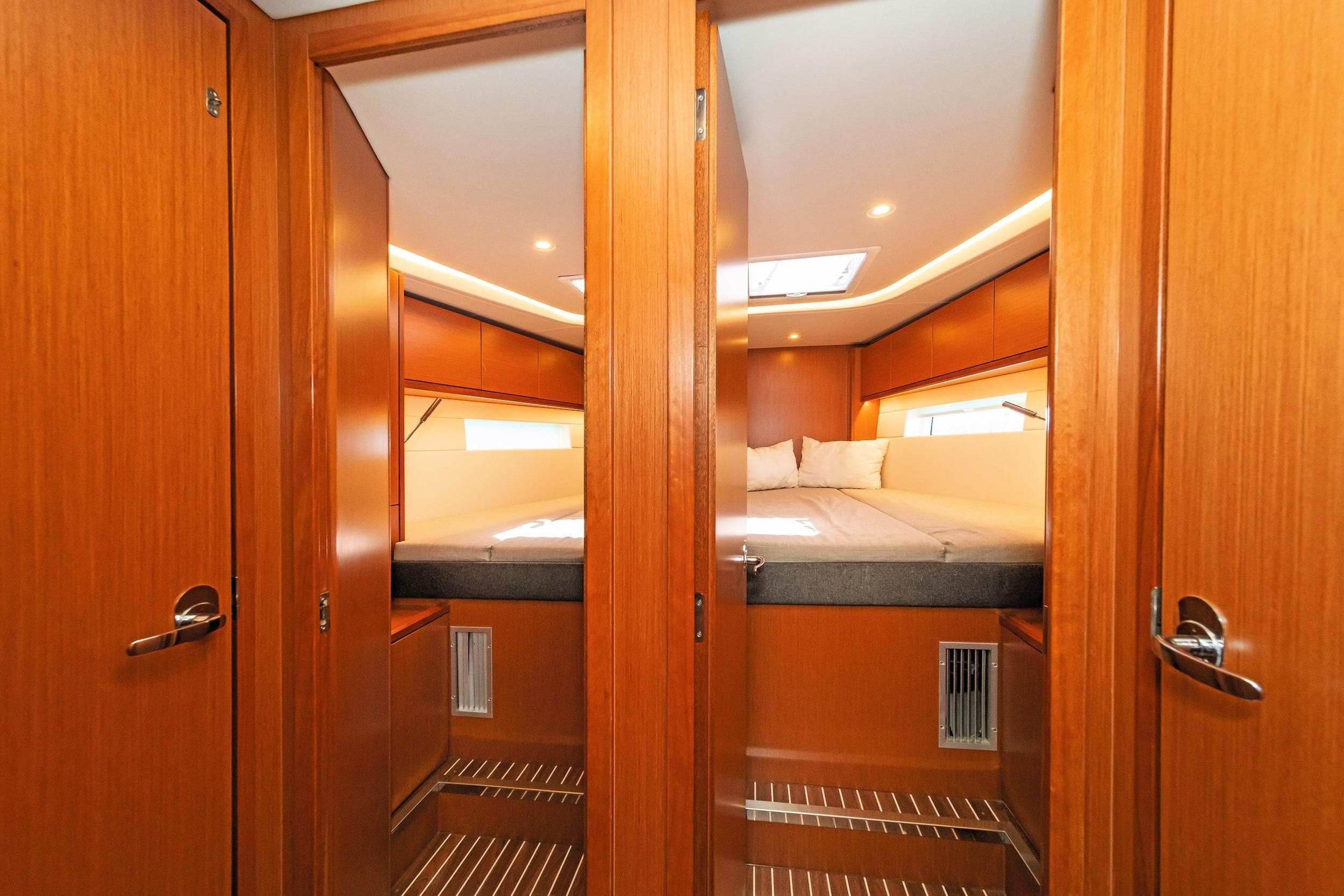 Luxurious interior of 2021 Bavaria C57 Style yacht cabin with wooden finish.