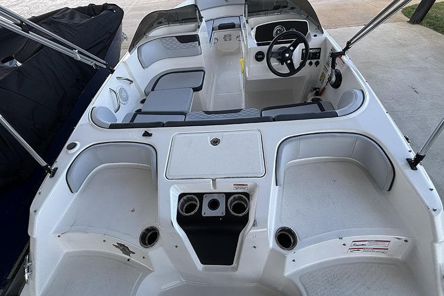 2024 Bayliner Element M17 boat interior with seating and steering console.