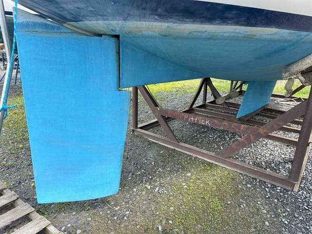 Pearson 36-2 sailboat keel and rudder, 1985 model, on a metal stand.