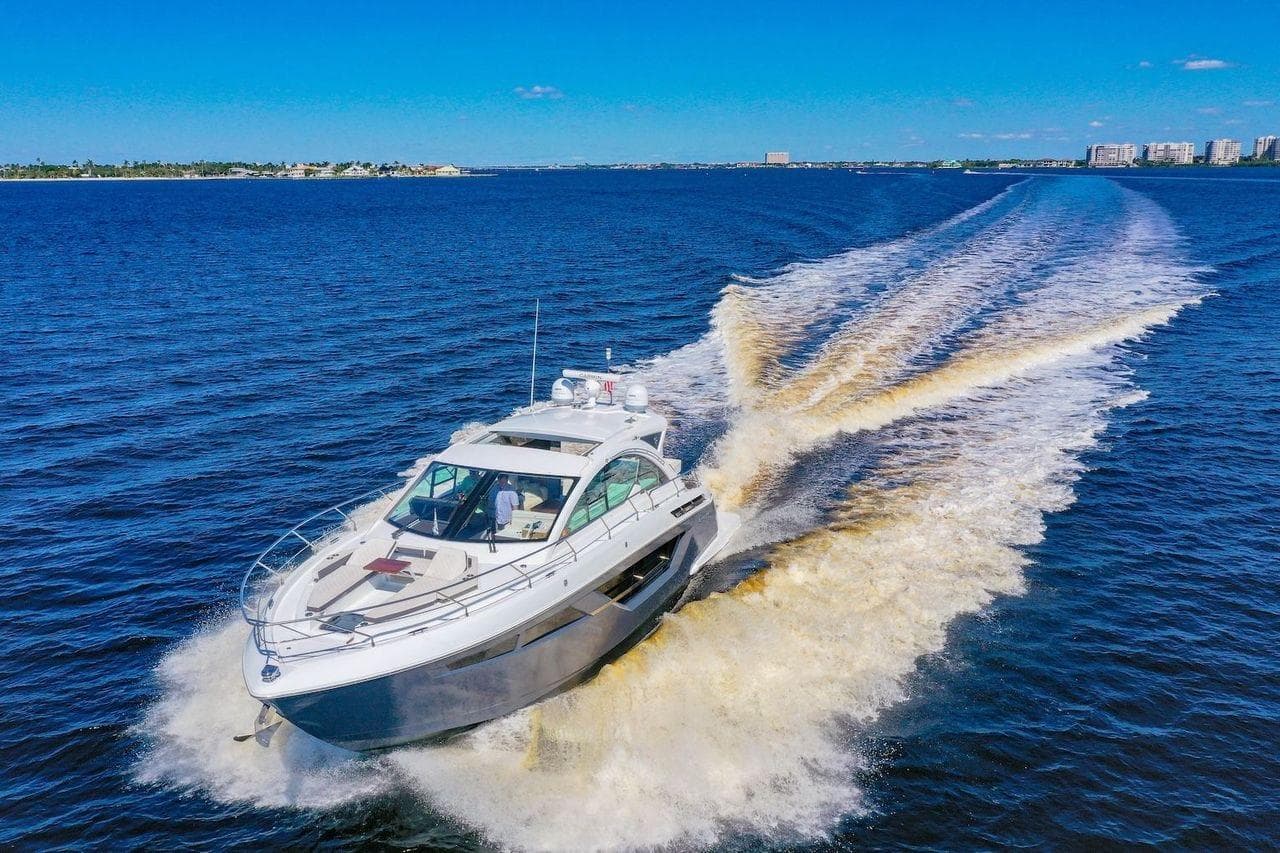 2020 Cruisers Yachts 50 Cantius cruising on open blue water, leaving a wake.