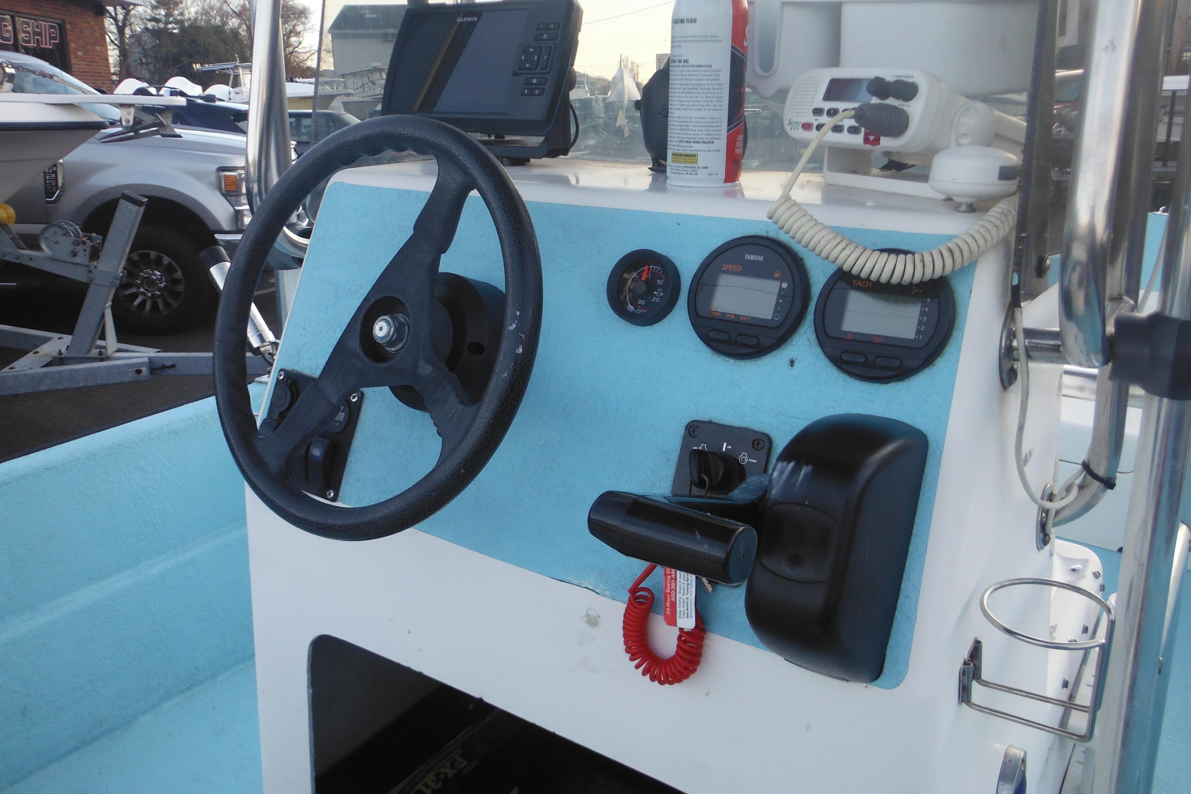 1998 Maritime Skiff 18 boat dashboard with steering wheel and navigation instruments.