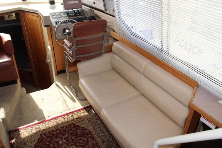 1997 Bayliner 4087 Aft Cabin Motoryacht interior with beige seating and helm station.
