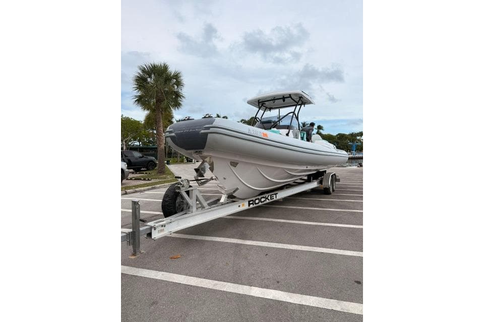 2024 Ranieri Cayman 27.0 Sport boat on trailer in parking lot.