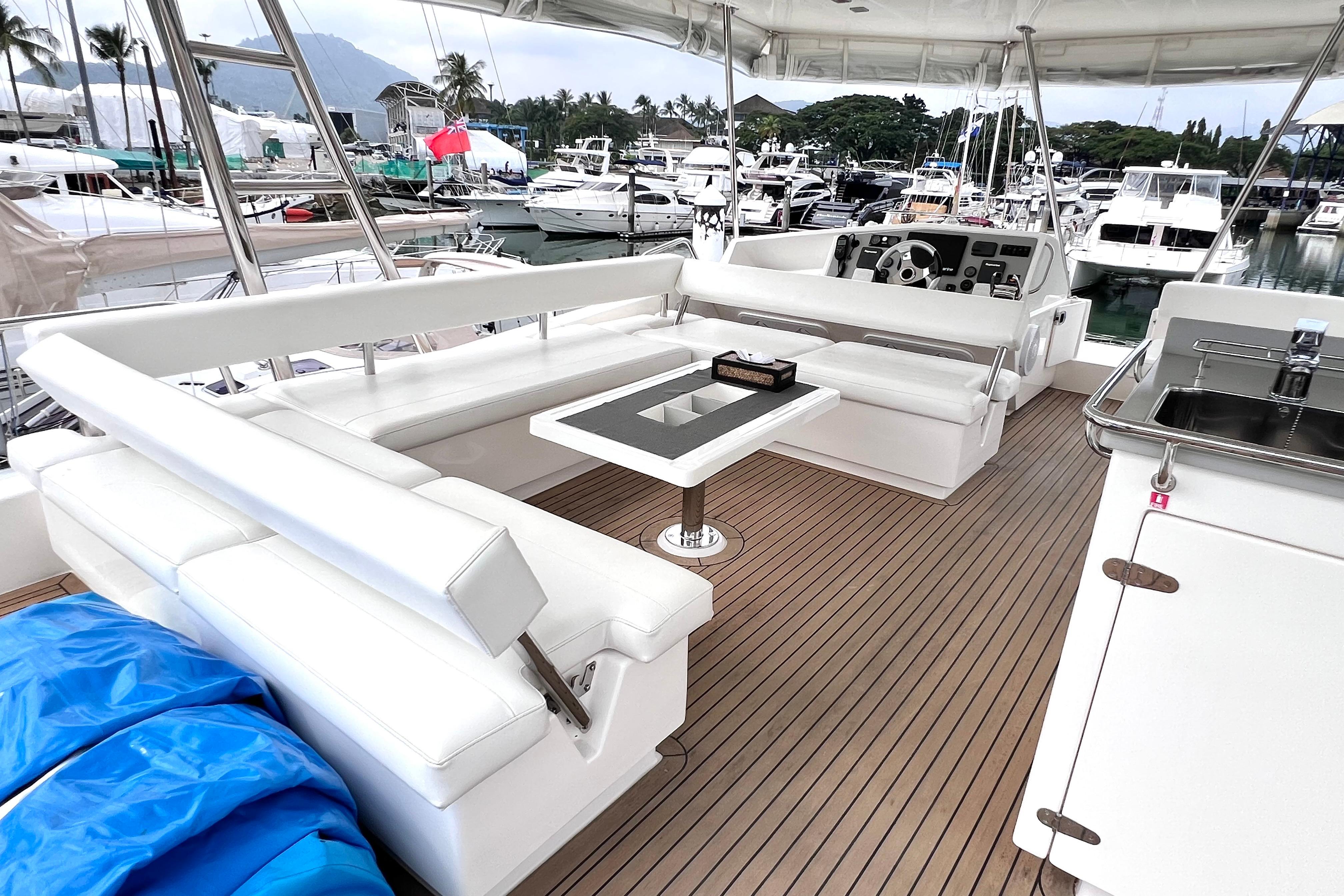 Luxurious 2019 Leopard 51 Powercat yacht interior with white seating and wooden deck.